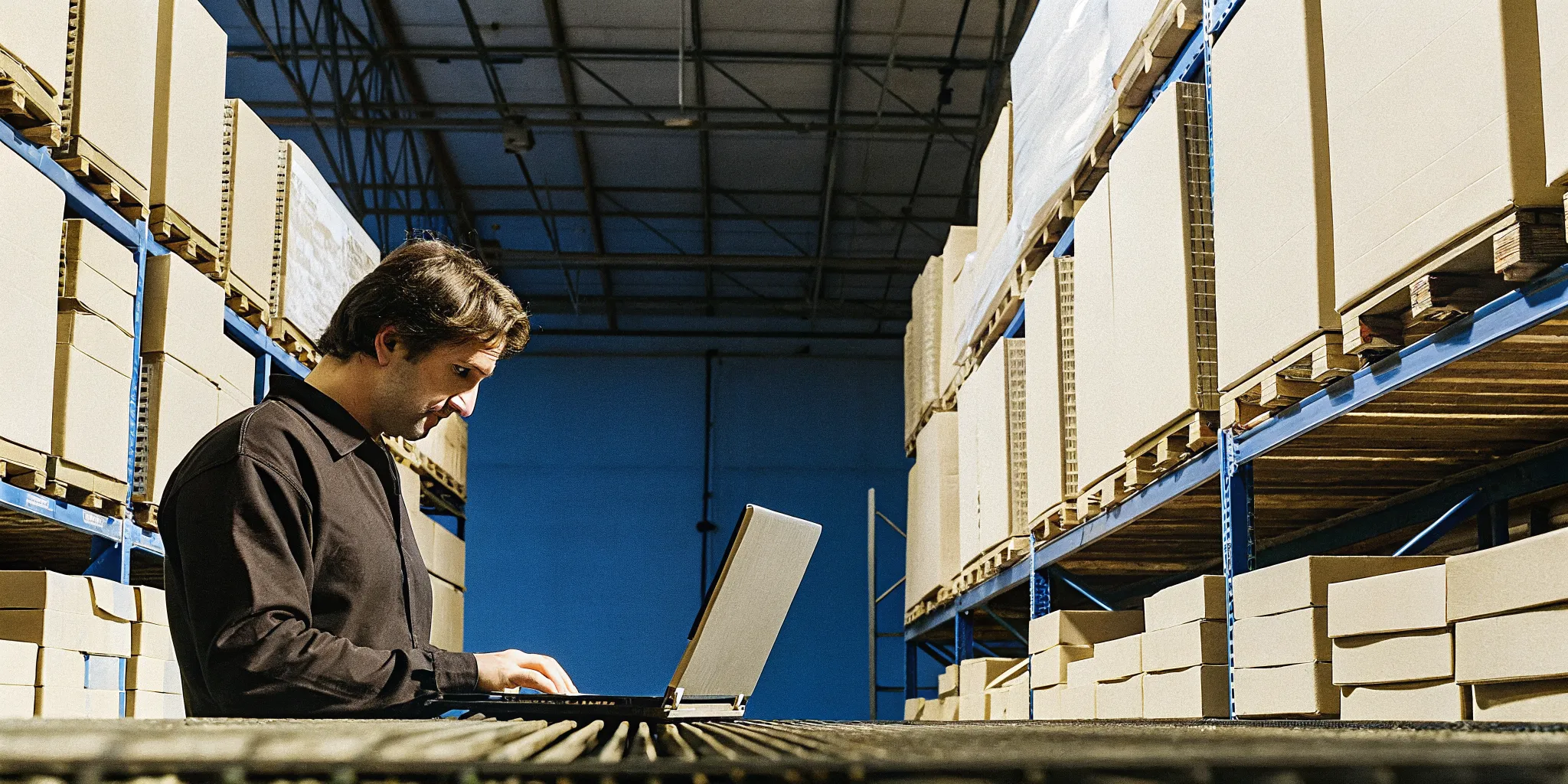 Operations manager reviewing returned inventory reports at a returns processing station