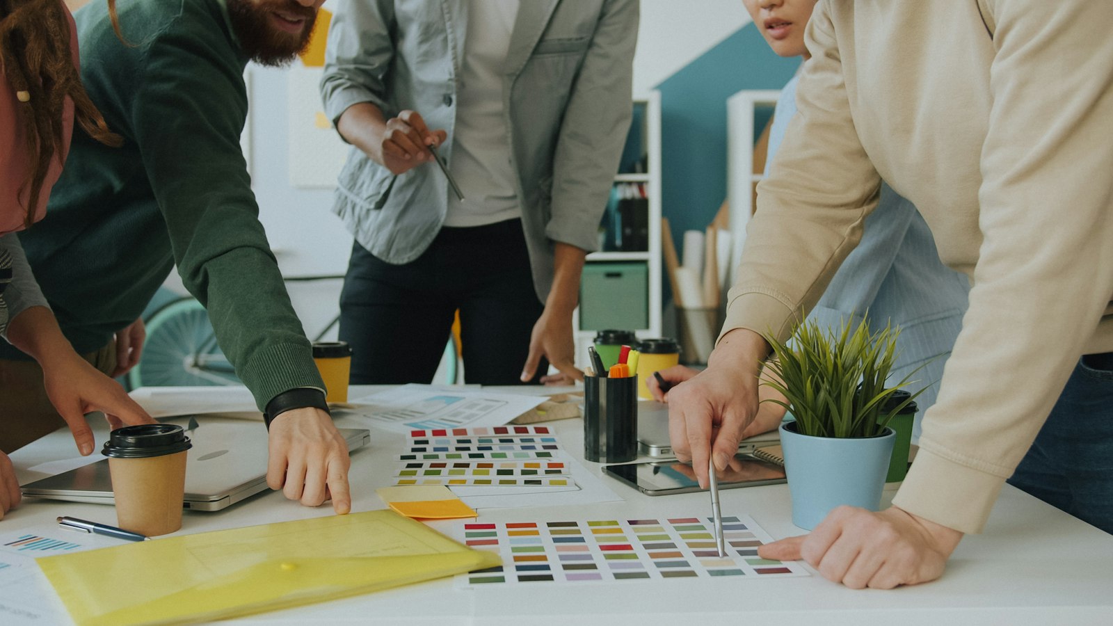 A design team reviews brand color swatches on a table