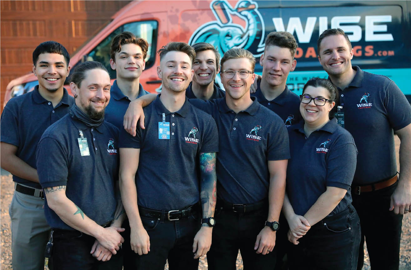 The Wise Coatings team in branded shirts in front of a wrapped van