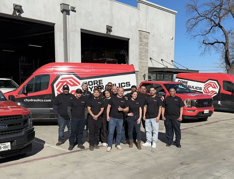 Core Hydraulics team and branded fleet at the DFW hose shop, original social photograph.