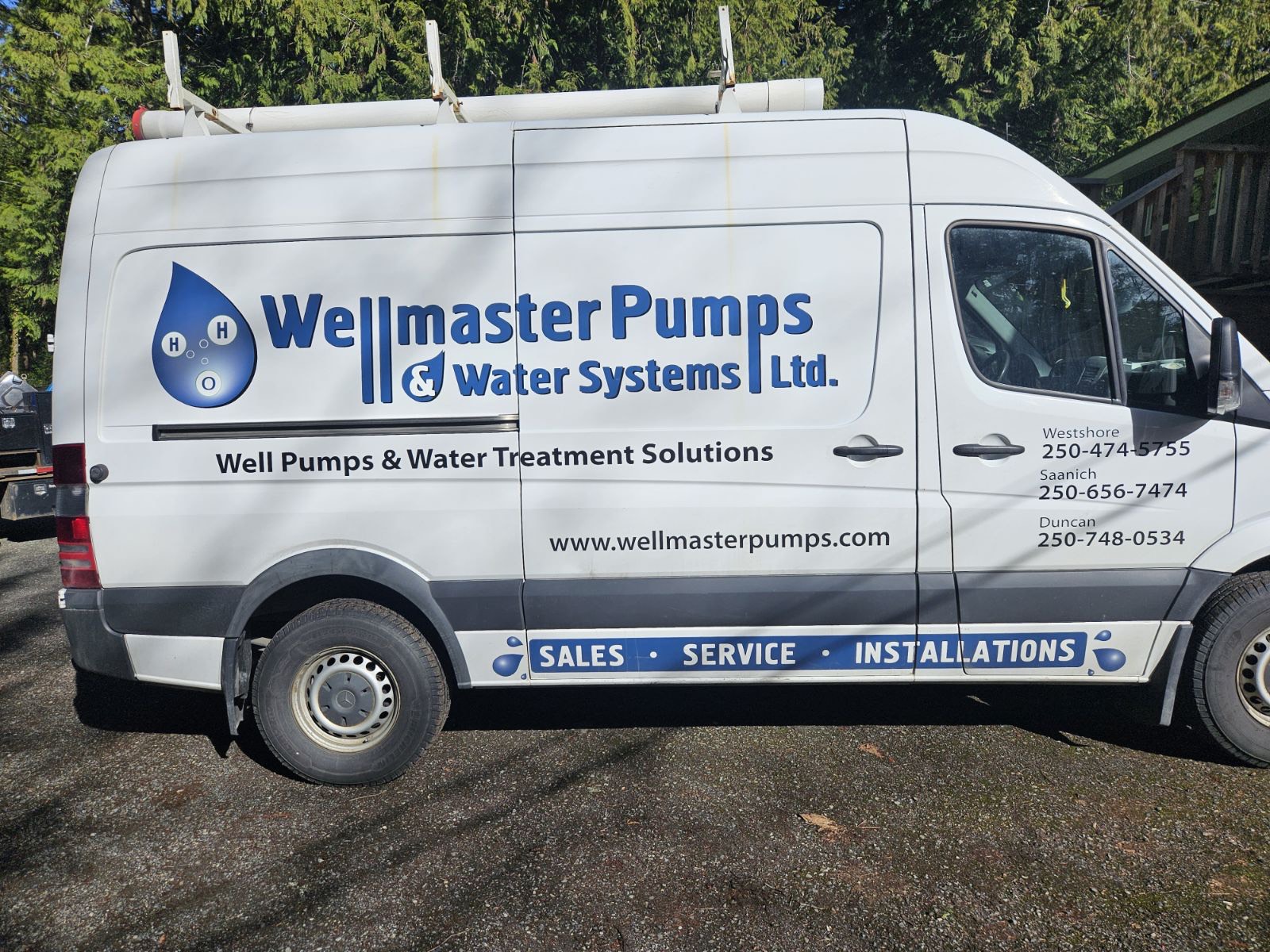 Before: original Wellmaster Pumps & Water Systems vehicle photograph.