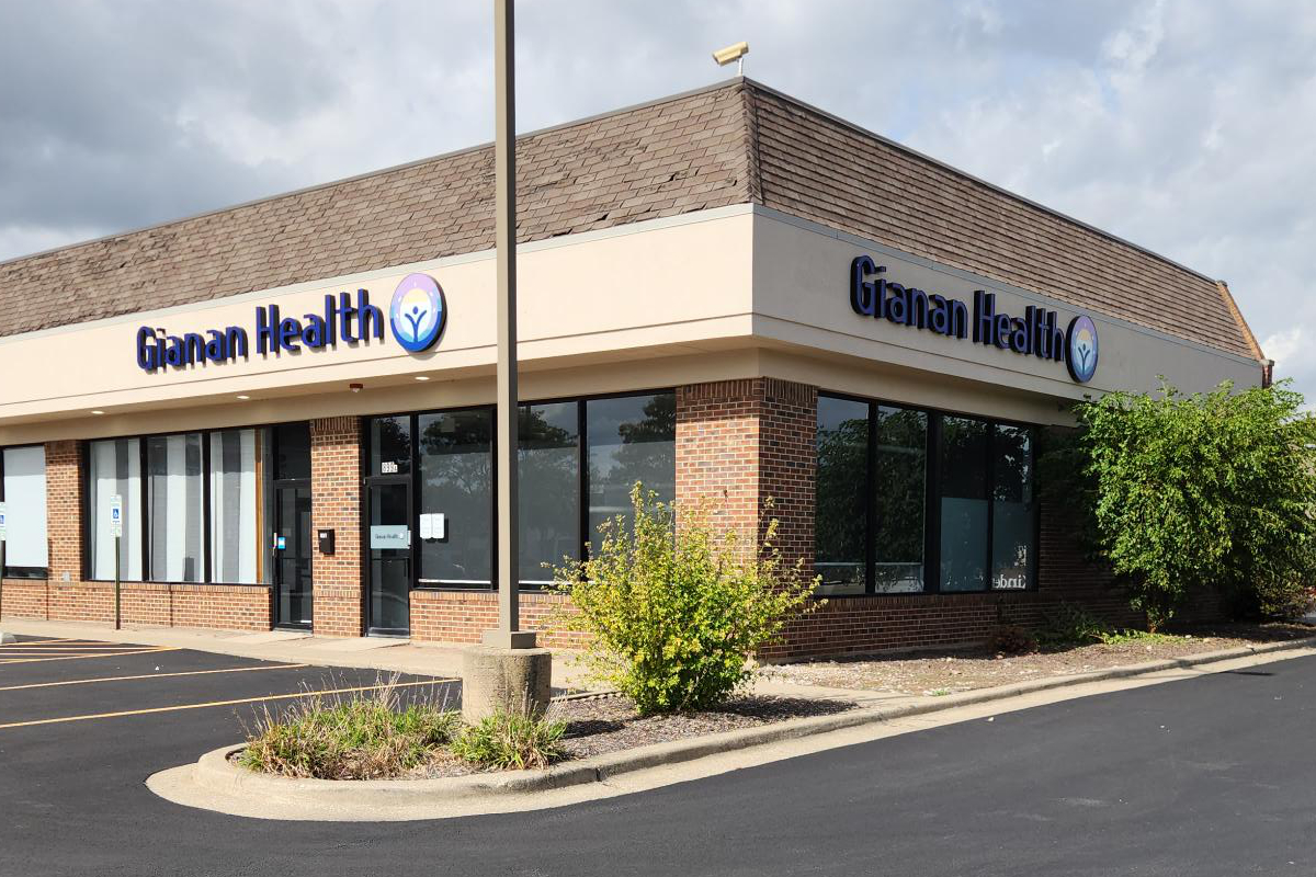 Sign reading 'Robert Q. Marshall, DDS SMILES Of Orland Park' with 'SMILES' in large blue letters and the rest in gray.