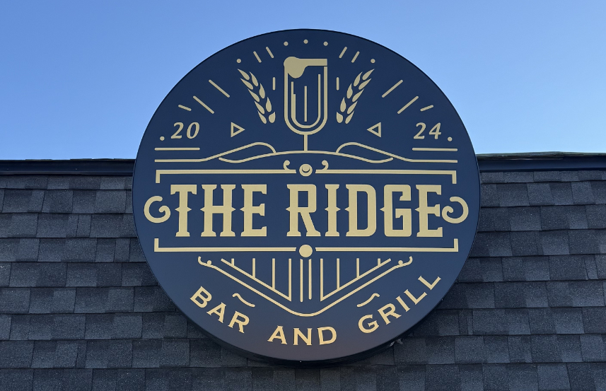 Kerlin Walsh Law office wall sign with the initials K W L and the tagline Warmth & Competence.