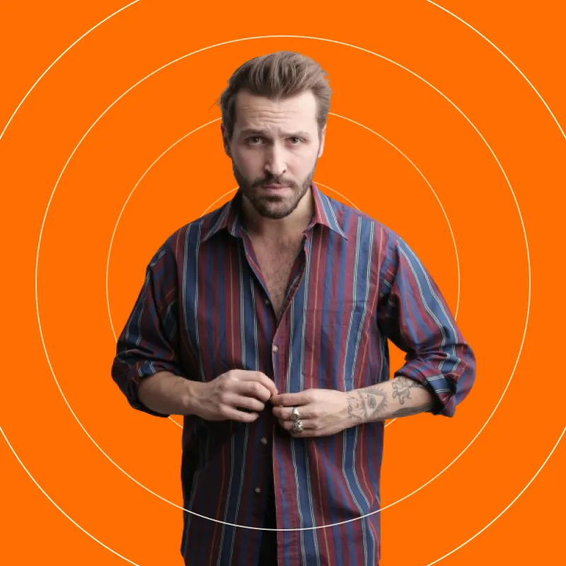 A man standing in front of an orange background.