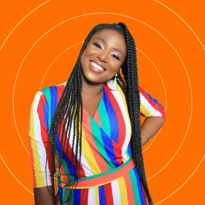 A woman wearing a multicolored dress and smiling.