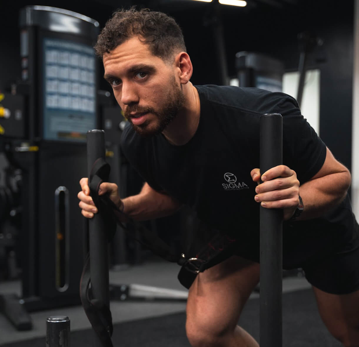 Man pushing a fitness sled in an athletic gym for HYROX training in River Oaks and west University Texas
