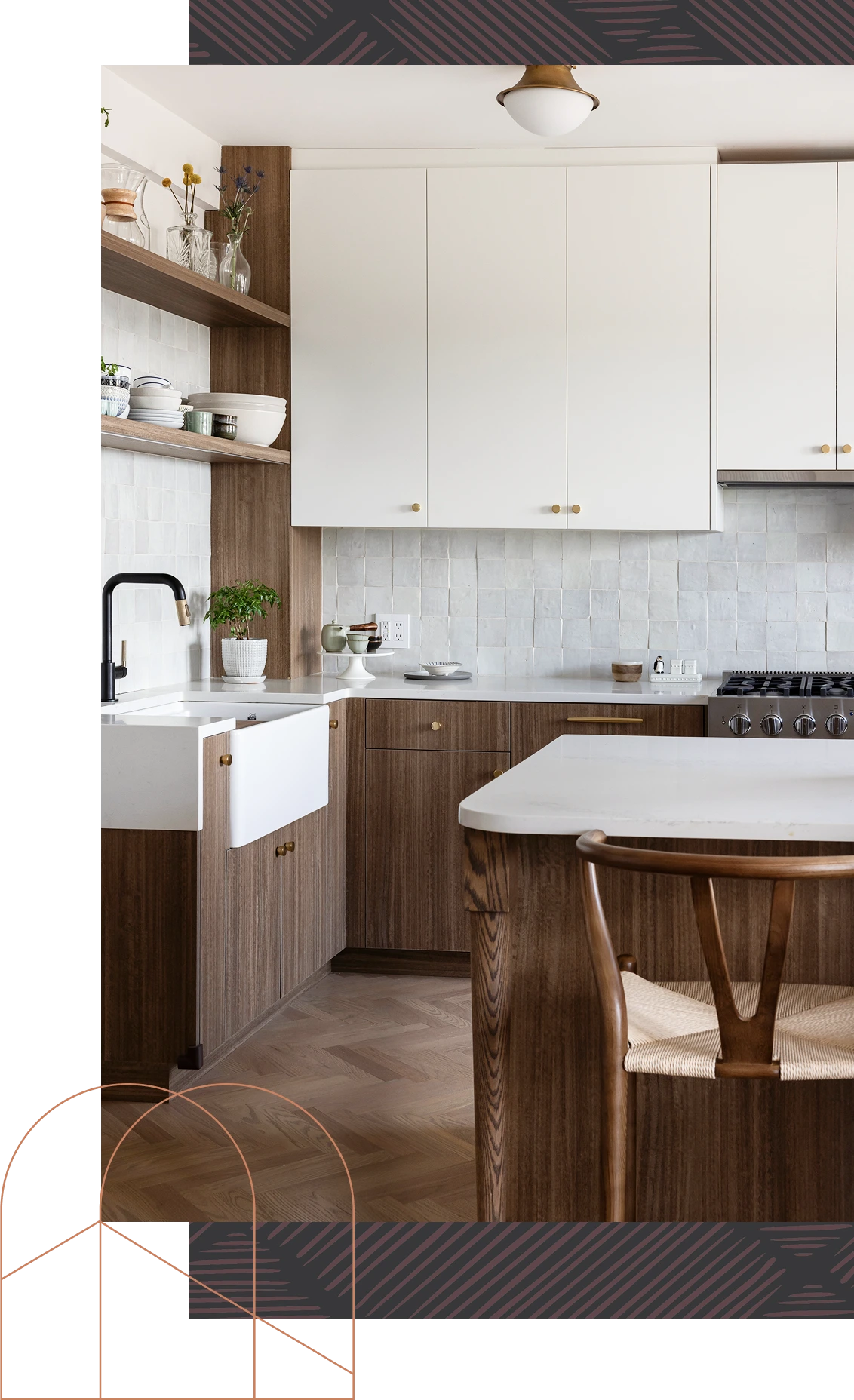 Modern kitchen with white upper cabinets, wood lower cabinets, marble countertops, and a wooden chair.
