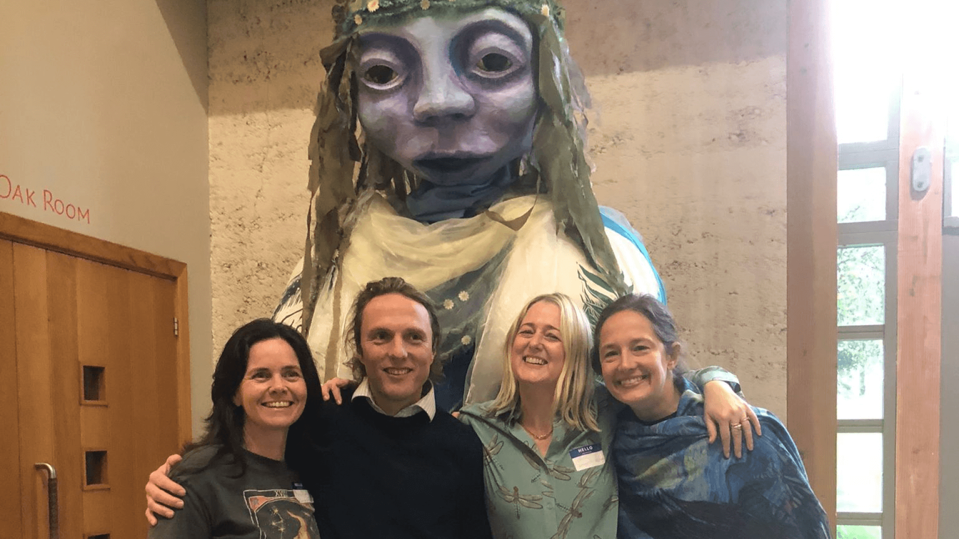Photograph of Lawyers for Nature team in front of large sculpture of a large human nature figure 