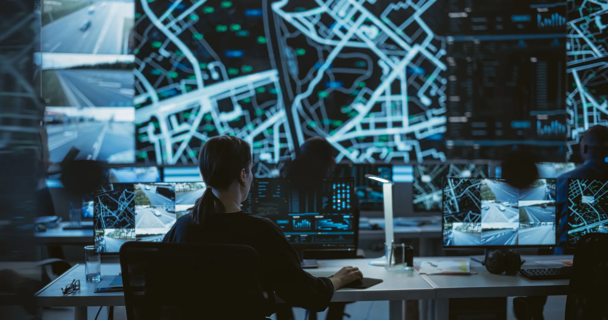 A person sitting at a desk analysing road data.