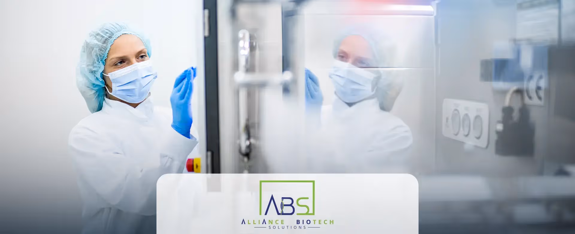 A woman wearing personal protective equipment assesses equipment in a laboratory setting. Her reflection appears in the glass. The Alliance Biotech Solutions logo is overlaid.