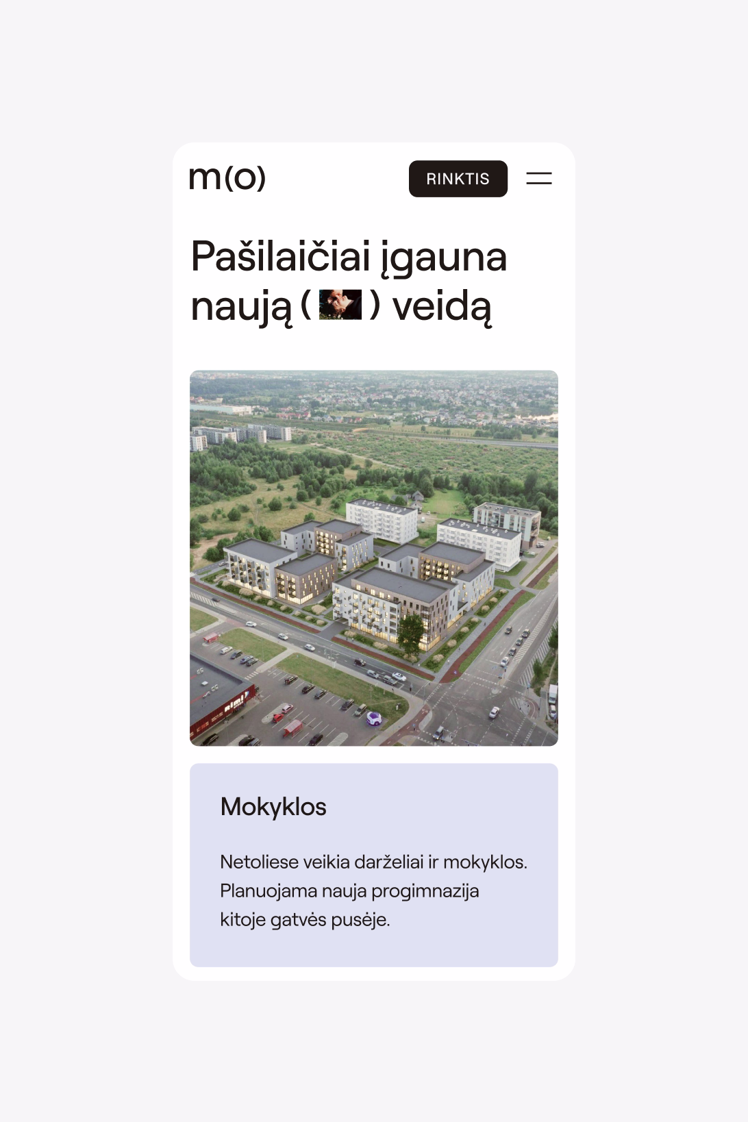 A webpage showing a residential area with several modern apartment buildings and green spaces.