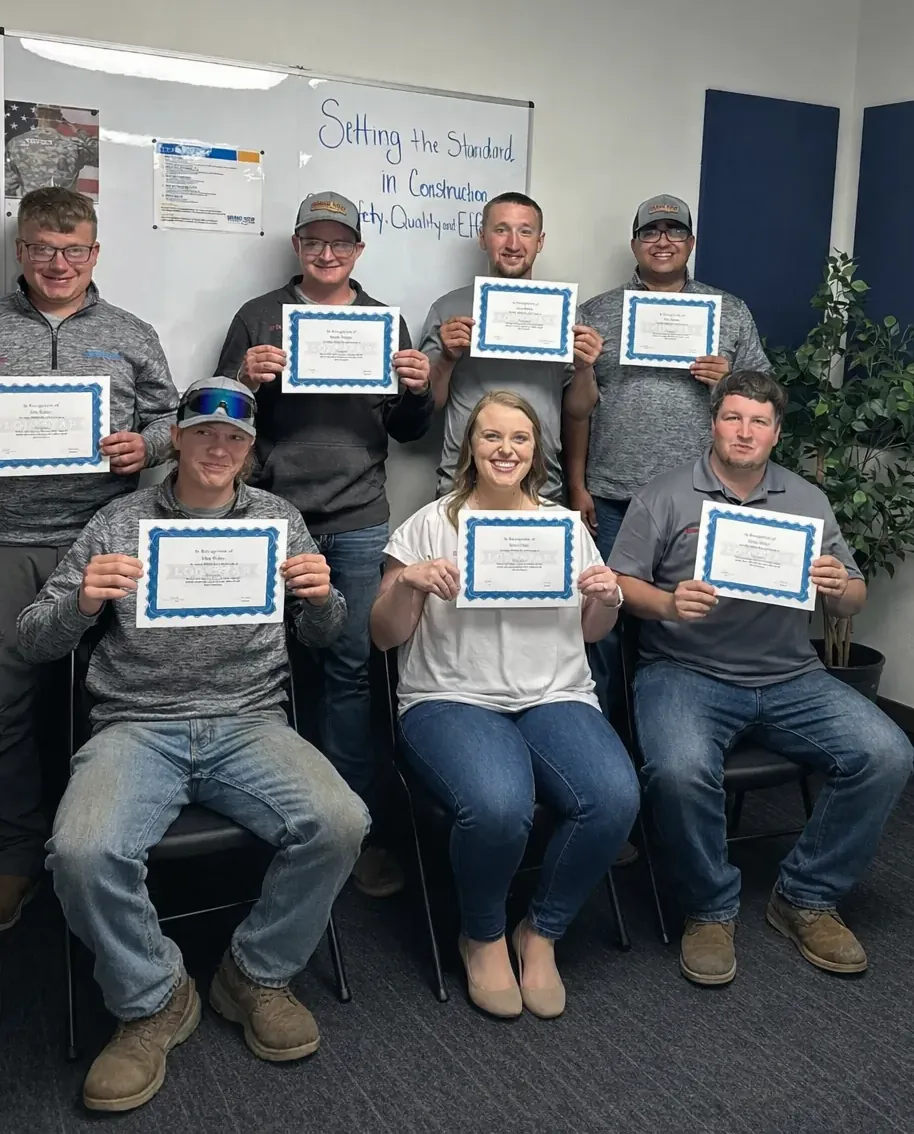 Wes Keim, Junior Miller, and Marion Miller standing next to eachother holding their character of the month awards