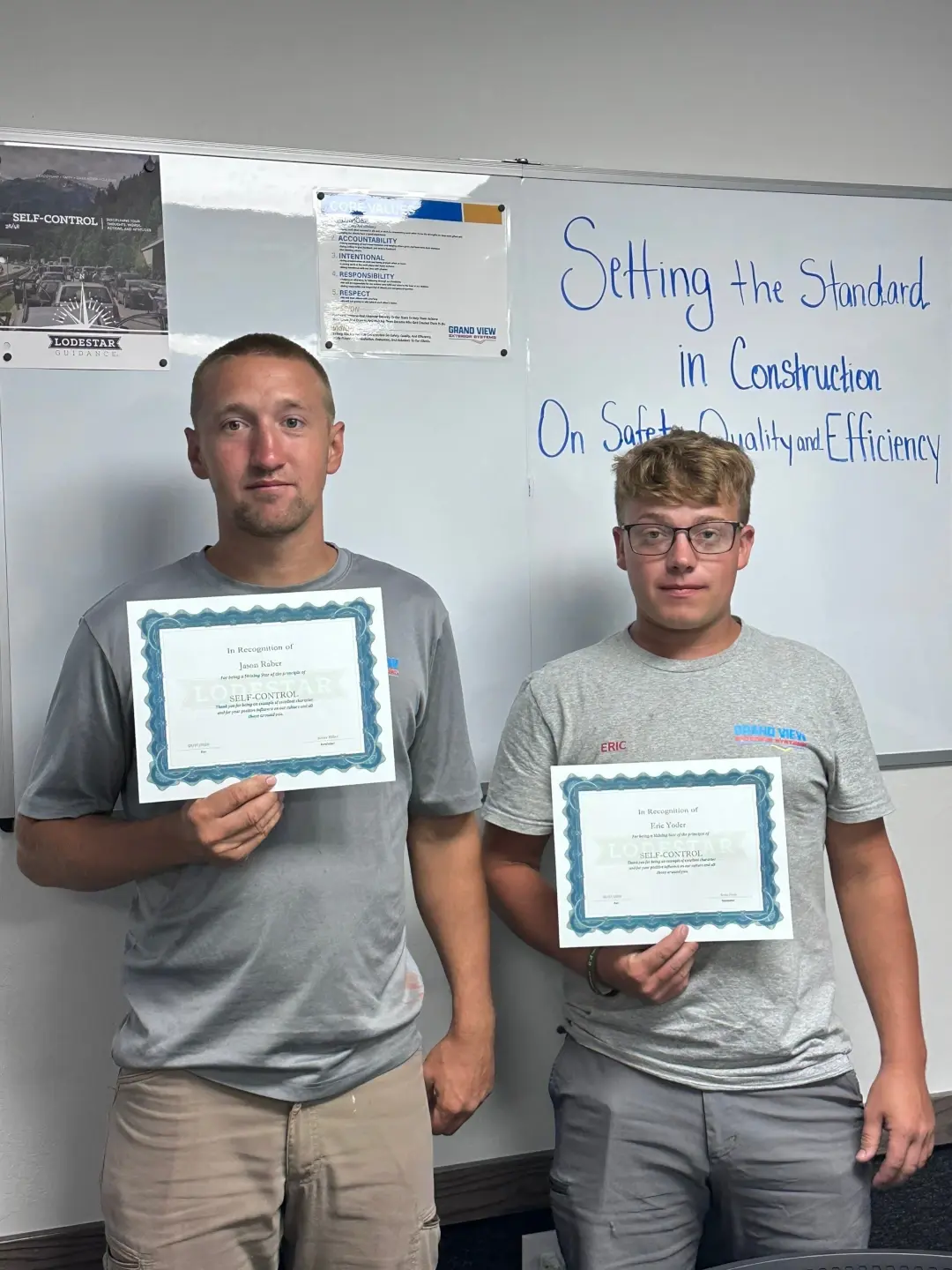 Wes Keim, Junior Miller, and Marion Miller standing next to eachother holding their character of the month awards