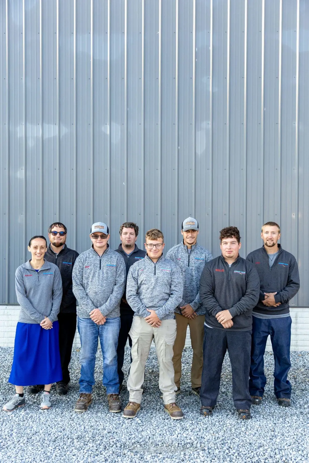 grand view team standing together with hands crossed