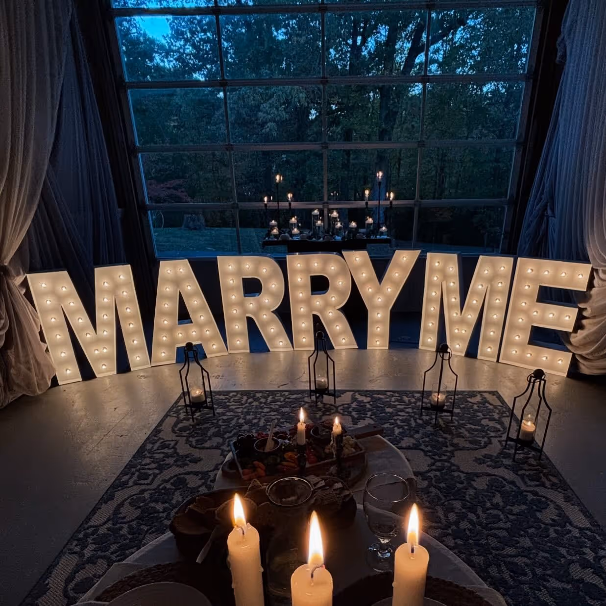 Lit letters spelling HVMS in front of silver and blue balloons at Hardin Valley Middle School with mural stars and music notes on the wall.