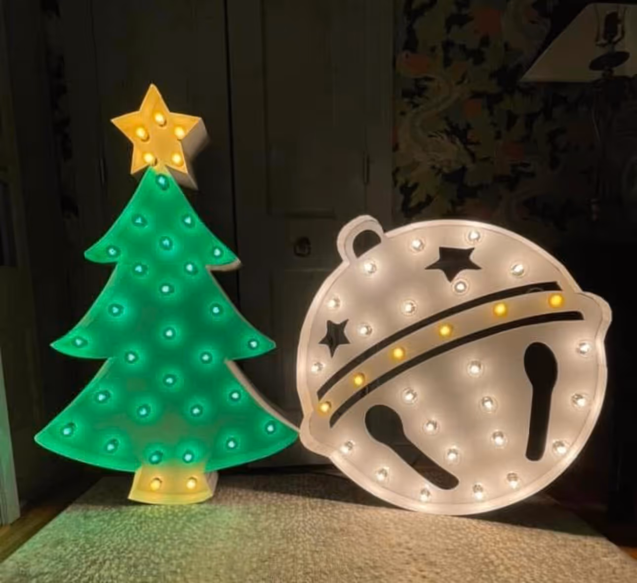 Lit letters spelling HVMS in front of silver and blue balloons at Hardin Valley Middle School with mural stars and music notes on the wall.