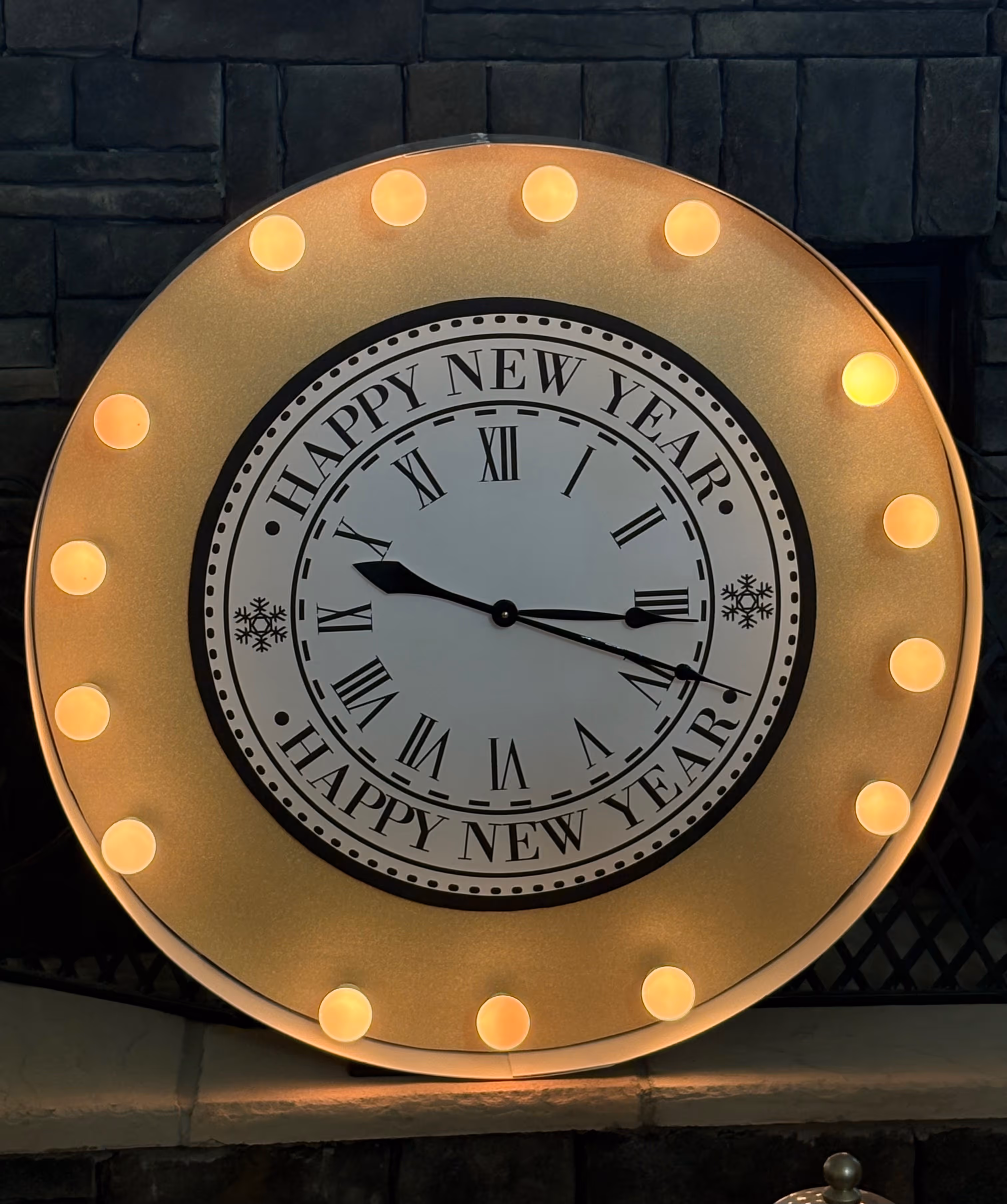 Lighted circular sign designed like a softball with orange and white bulbs and the text 'Vols' and two orange T letters.