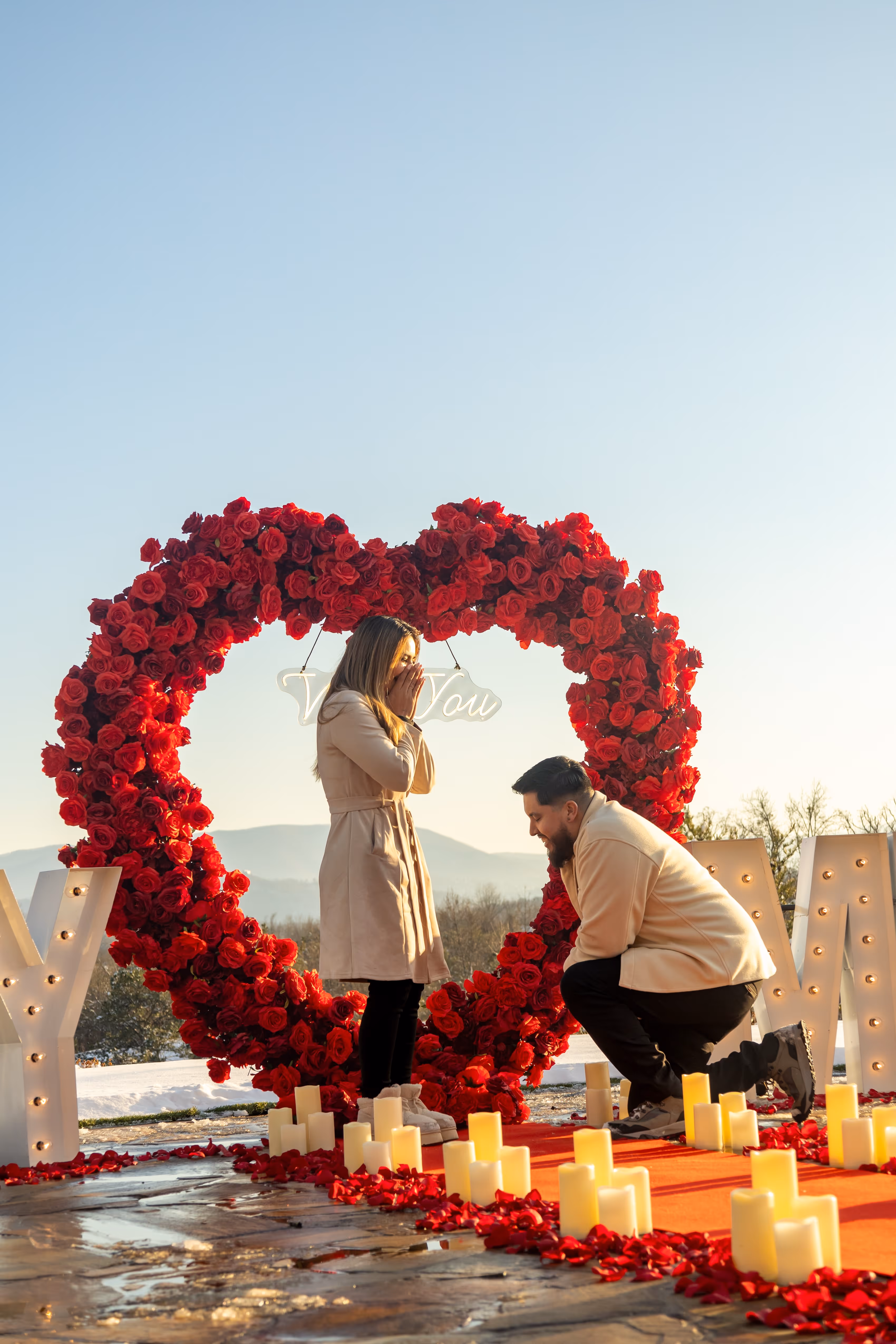 Lit letters spelling HVMS in front of silver and blue balloons at Hardin Valley Middle School with mural stars and music notes on the wall.