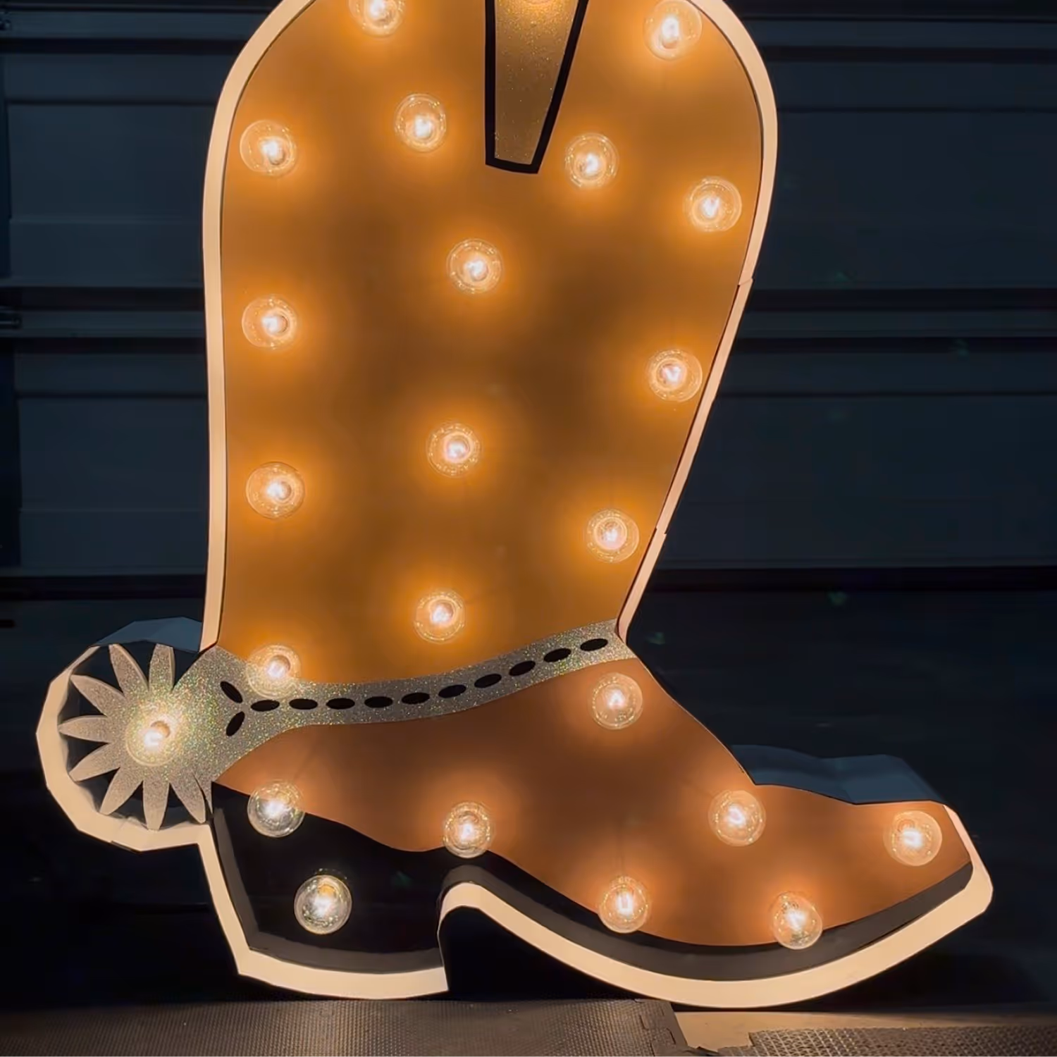 Lit letters spelling HVMS in front of silver and blue balloons at Hardin Valley Middle School with mural stars and music notes on the wall.