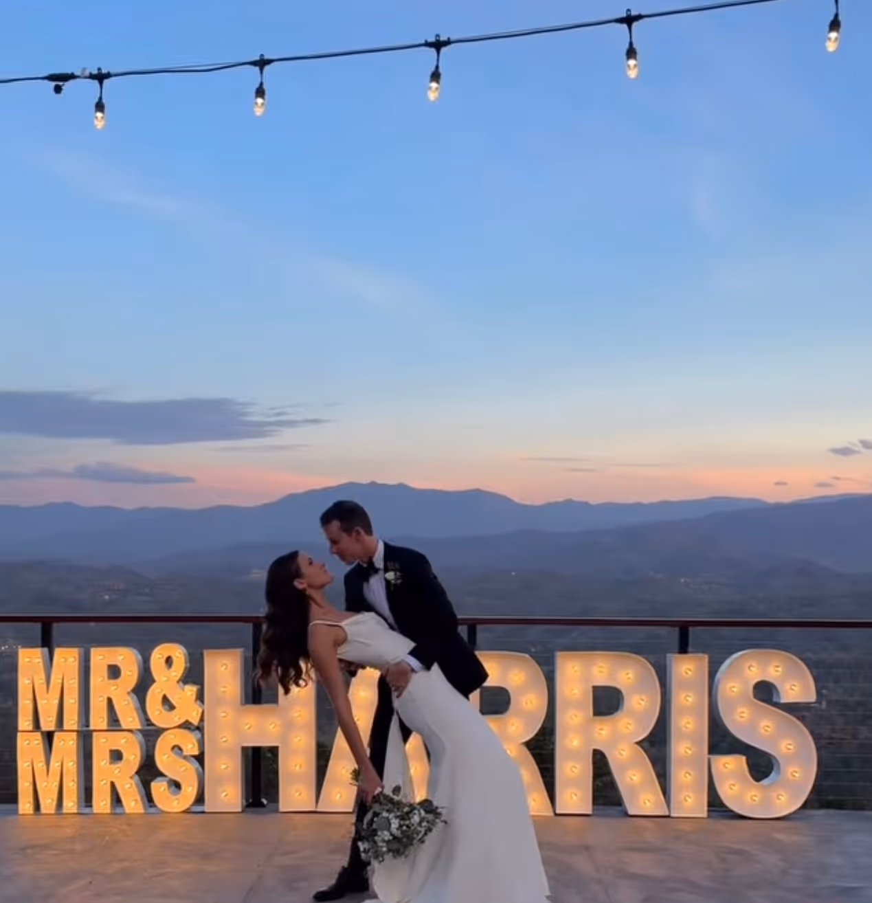 Lit letters spelling HVMS in front of silver and blue balloons at Hardin Valley Middle School with mural stars and music notes on the wall.