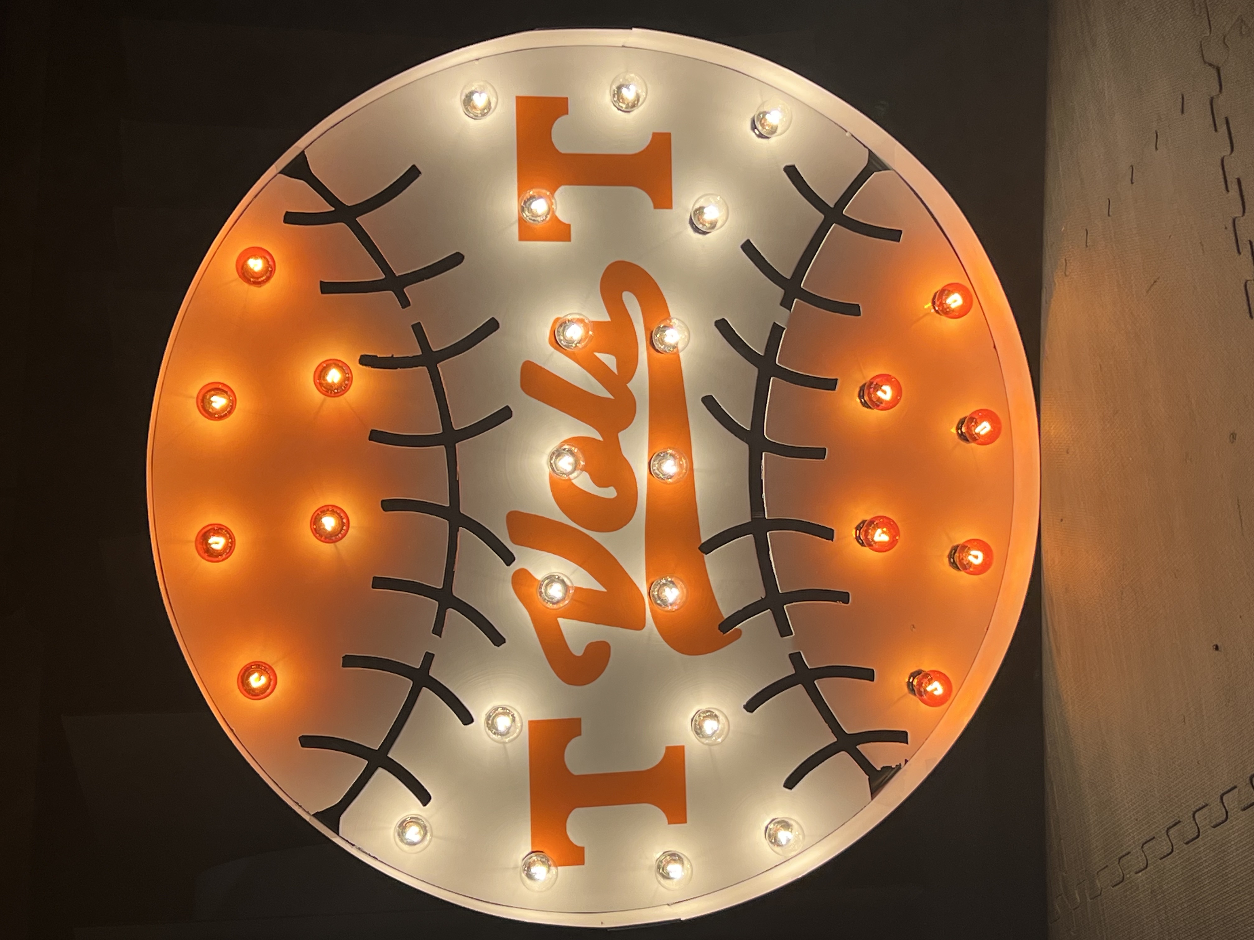 Lit letters spelling HVMS in front of silver and blue balloons at Hardin Valley Middle School with mural stars and music notes on the wall.