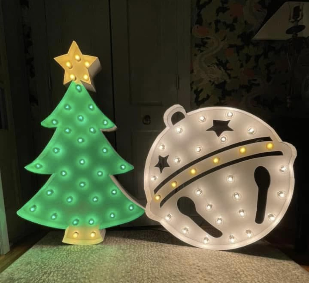 Lit letters spelling HVMS in front of silver and blue balloons at Hardin Valley Middle School with mural stars and music notes on the wall.