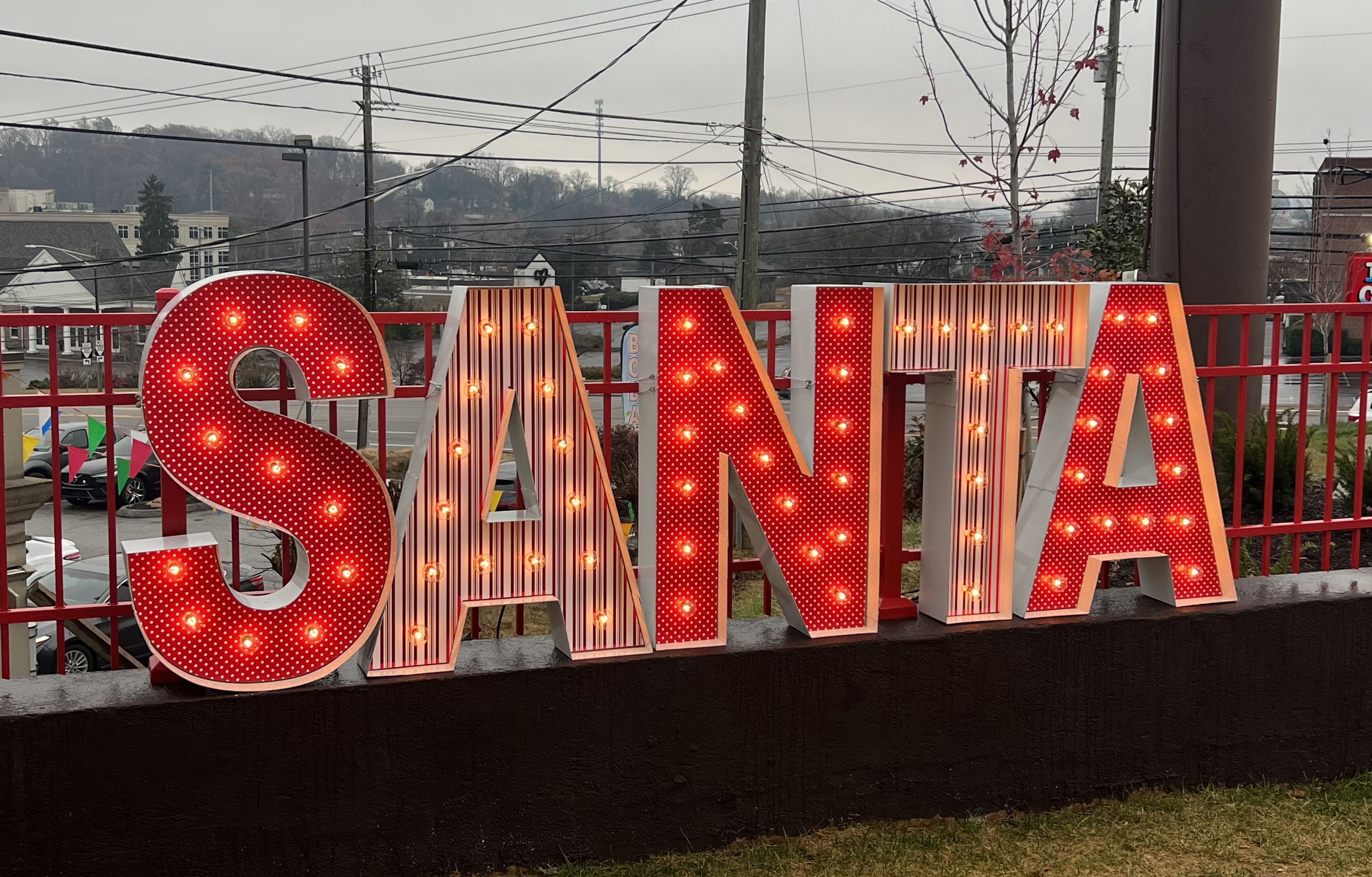 Lit letters spelling HVMS in front of silver and blue balloons at Hardin Valley Middle School with mural stars and music notes on the wall.