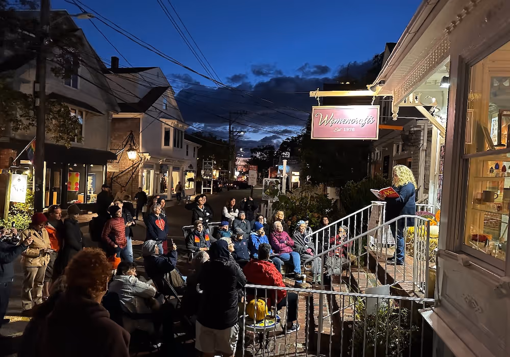 Night time reading held on the front steps of Womencrafts in Provincetown, MA