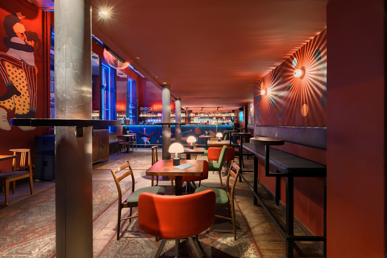 Bar interior with a teal counter, shelves stocked with liquor bottles, a disco ball hanging from the ceiling, and a red neon sign reading 'BEEFEATER'.