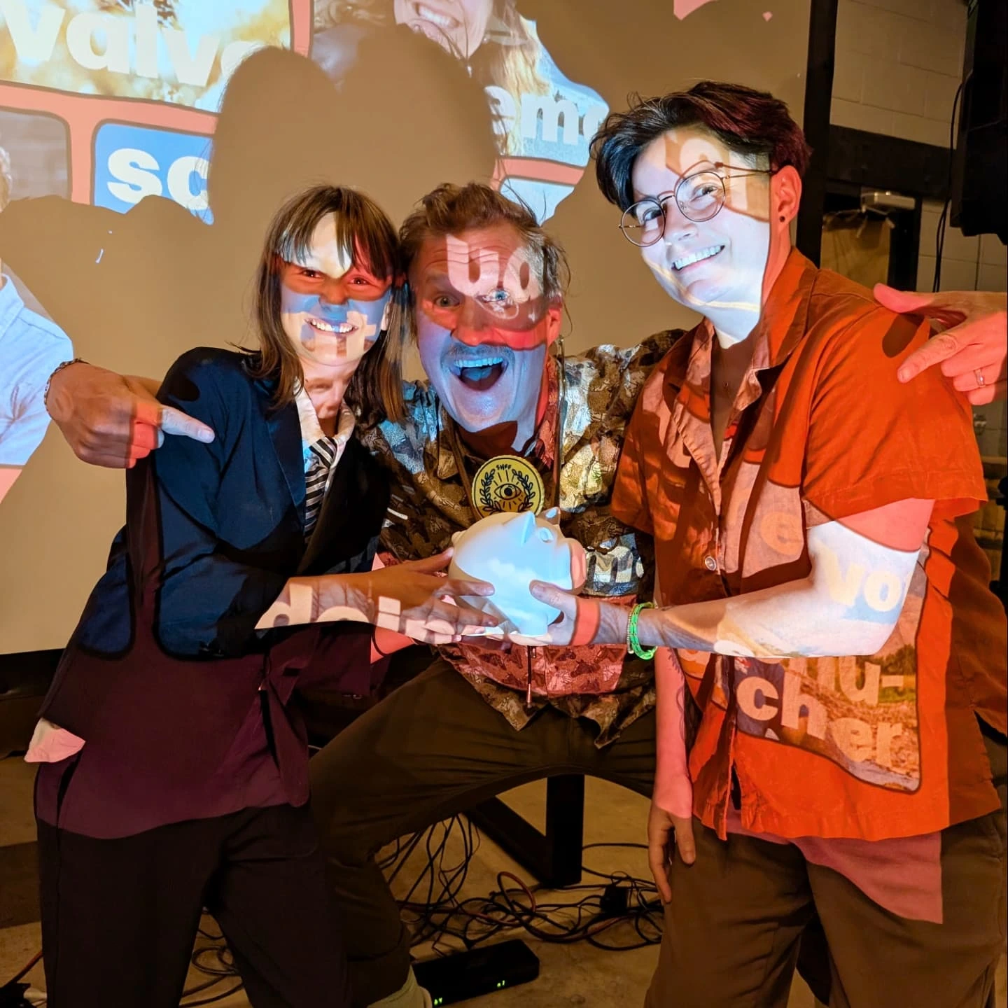 2025 Side Hustle Film Fest Poppin' Visuals winners Luke Trautwein with daughter Pearl and Gina Valvo β holding the 3D printed coin pig award