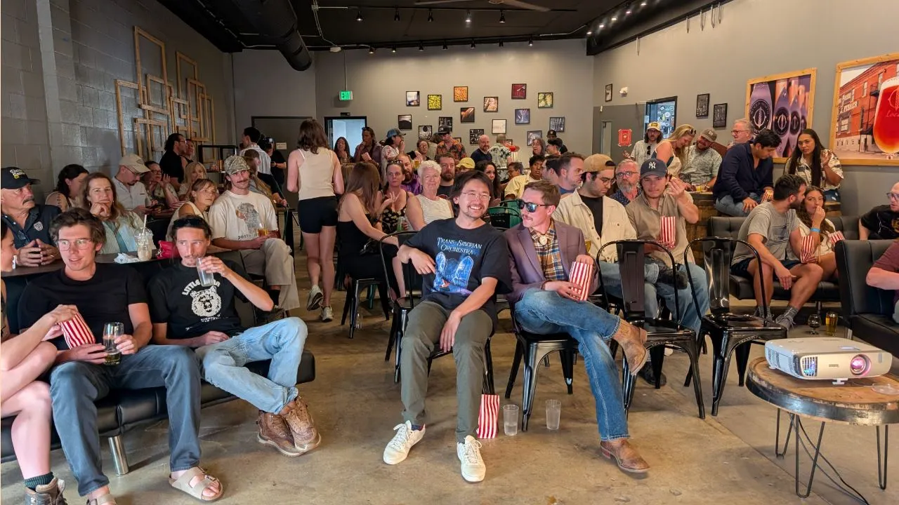 audience members talking before the Side Hustle Film Fest 2025 begins in the River North Brewery