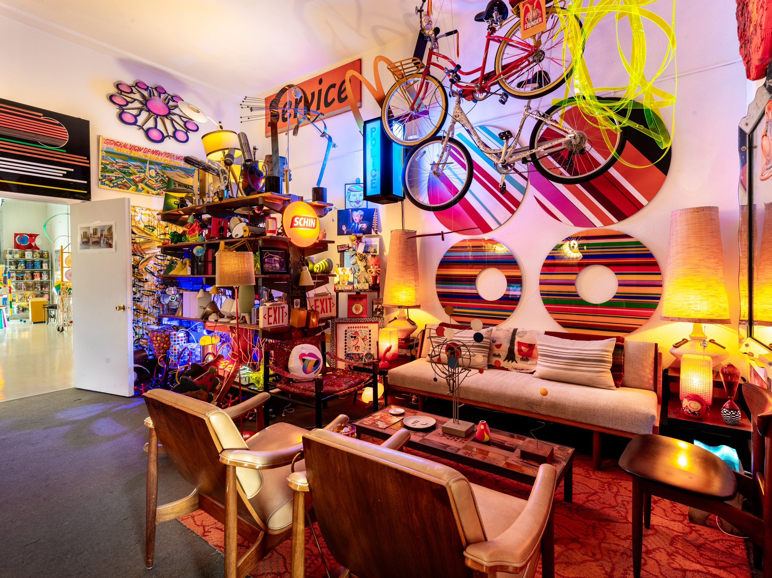 Lounge with suspended bicycles, striped murals and vintage lamps
