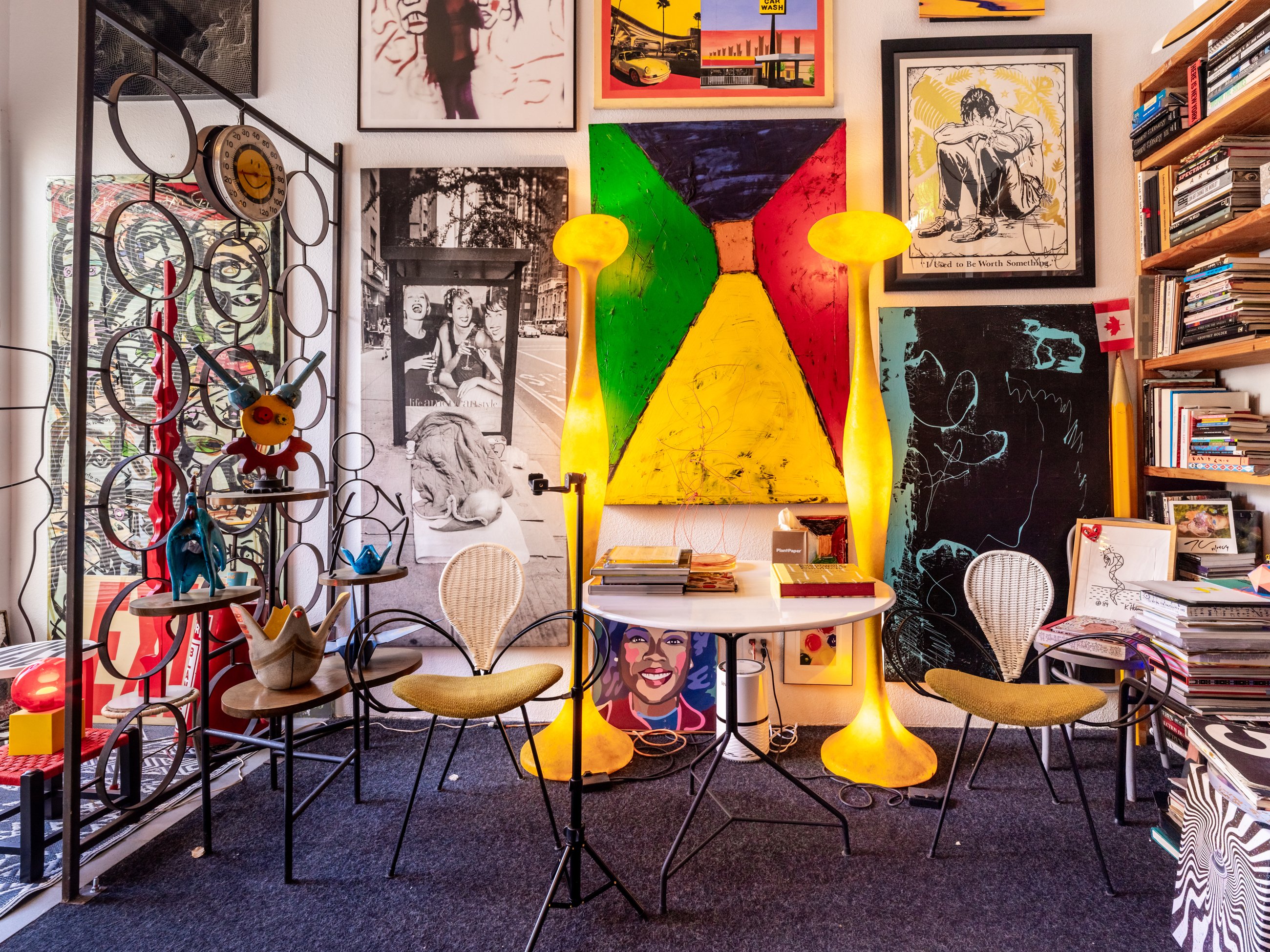 Reading corner with glowing floor lamps, art and books