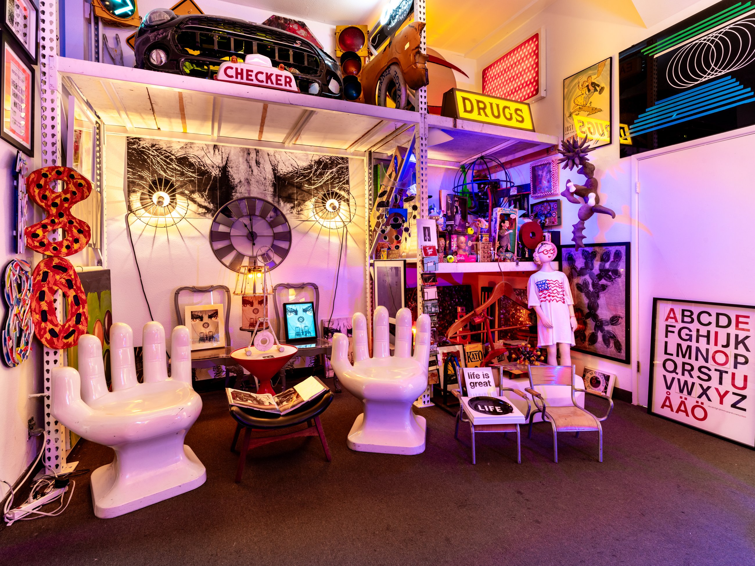 Pop art room with hand chairs, vintage signs and collectibles
