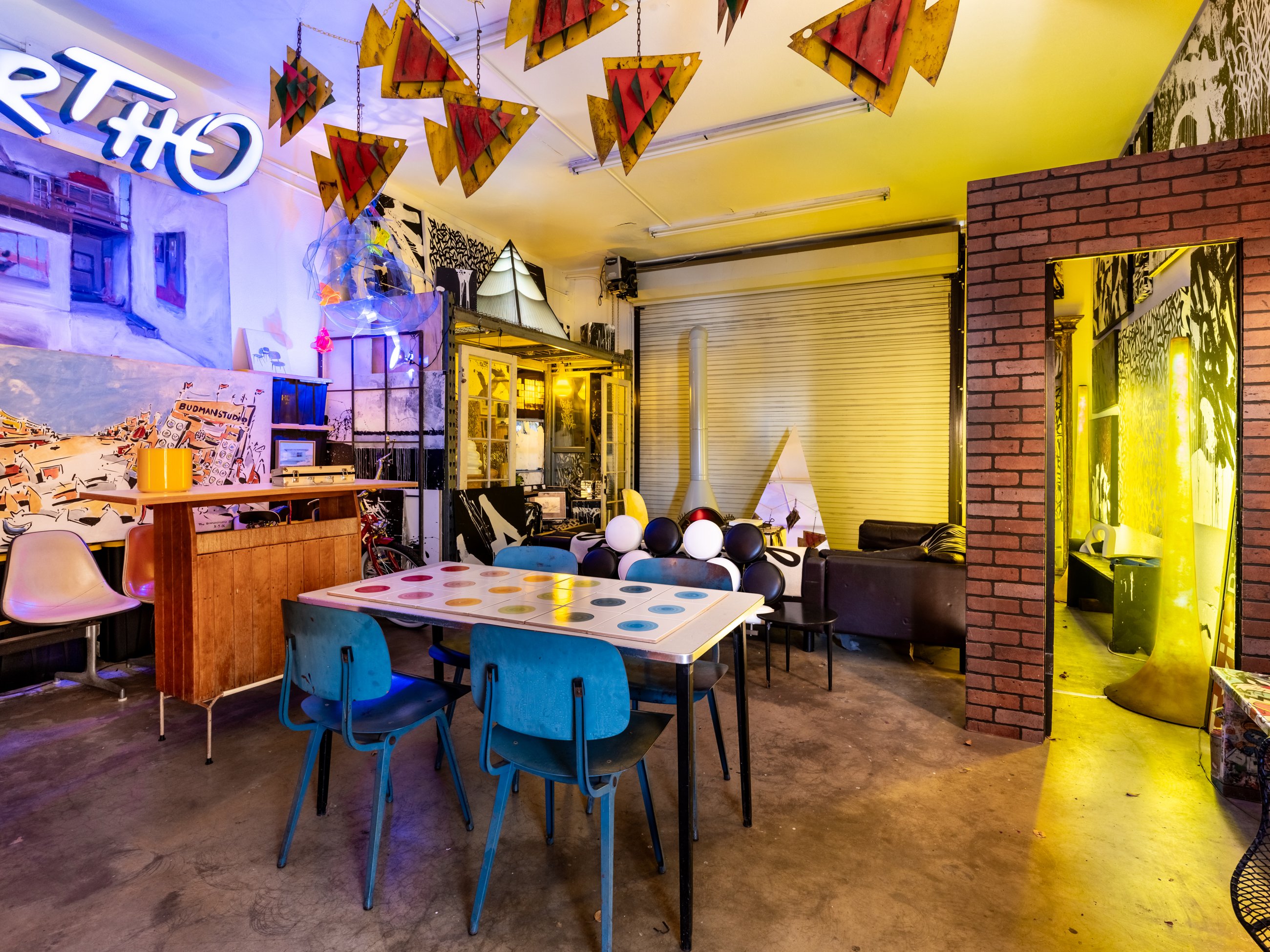 Dining area with blue chairs, bar and neon signage