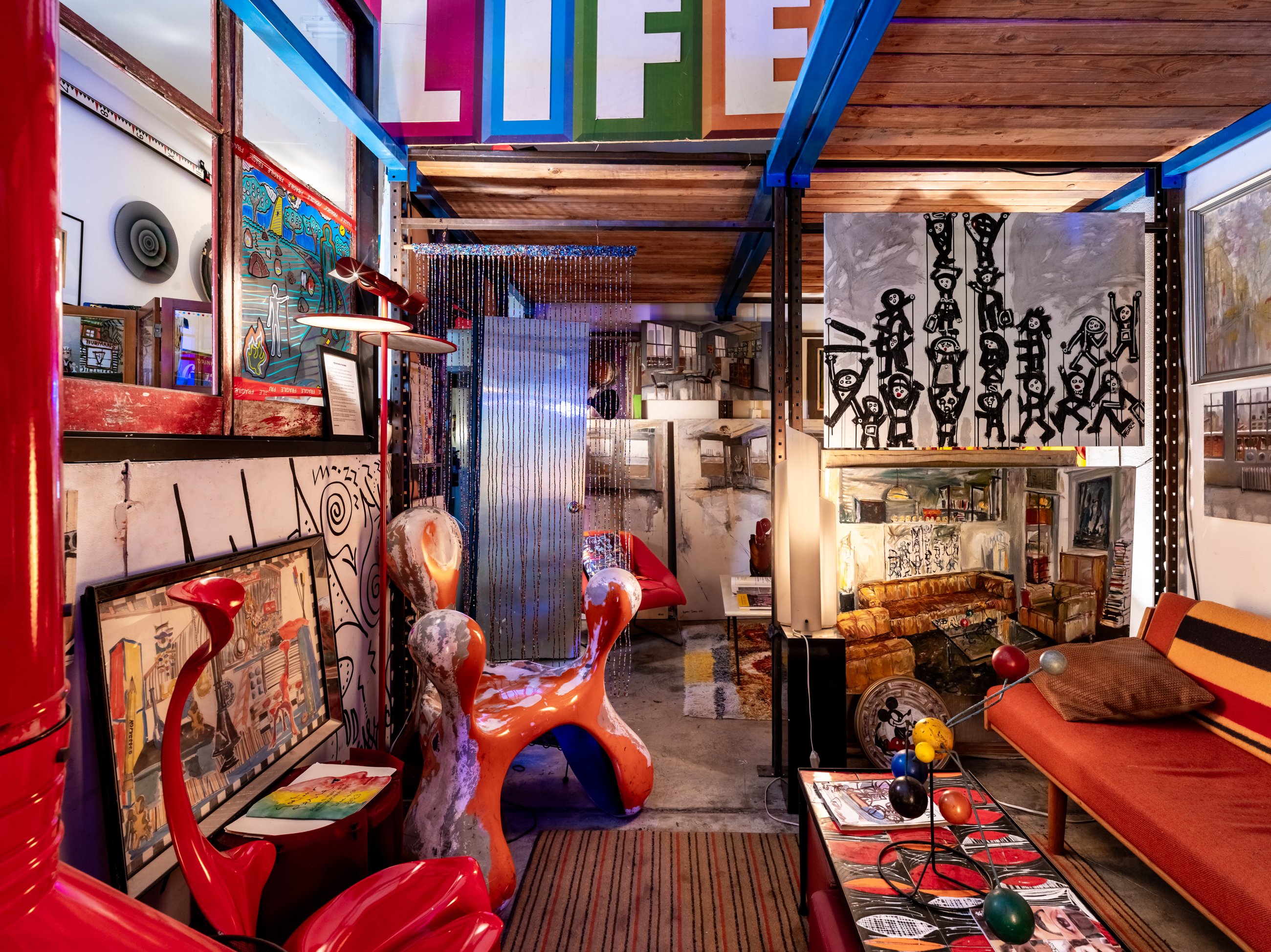Timber loft lounge beneath oversized LIFE lettering