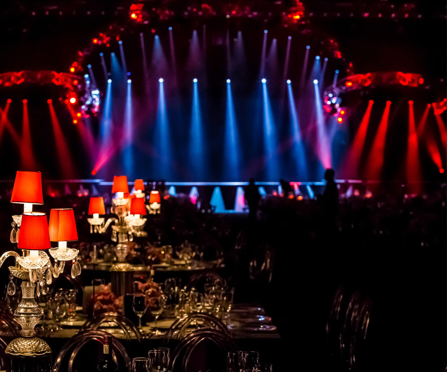 A stage illuminated by streaks of bright blue and red light
