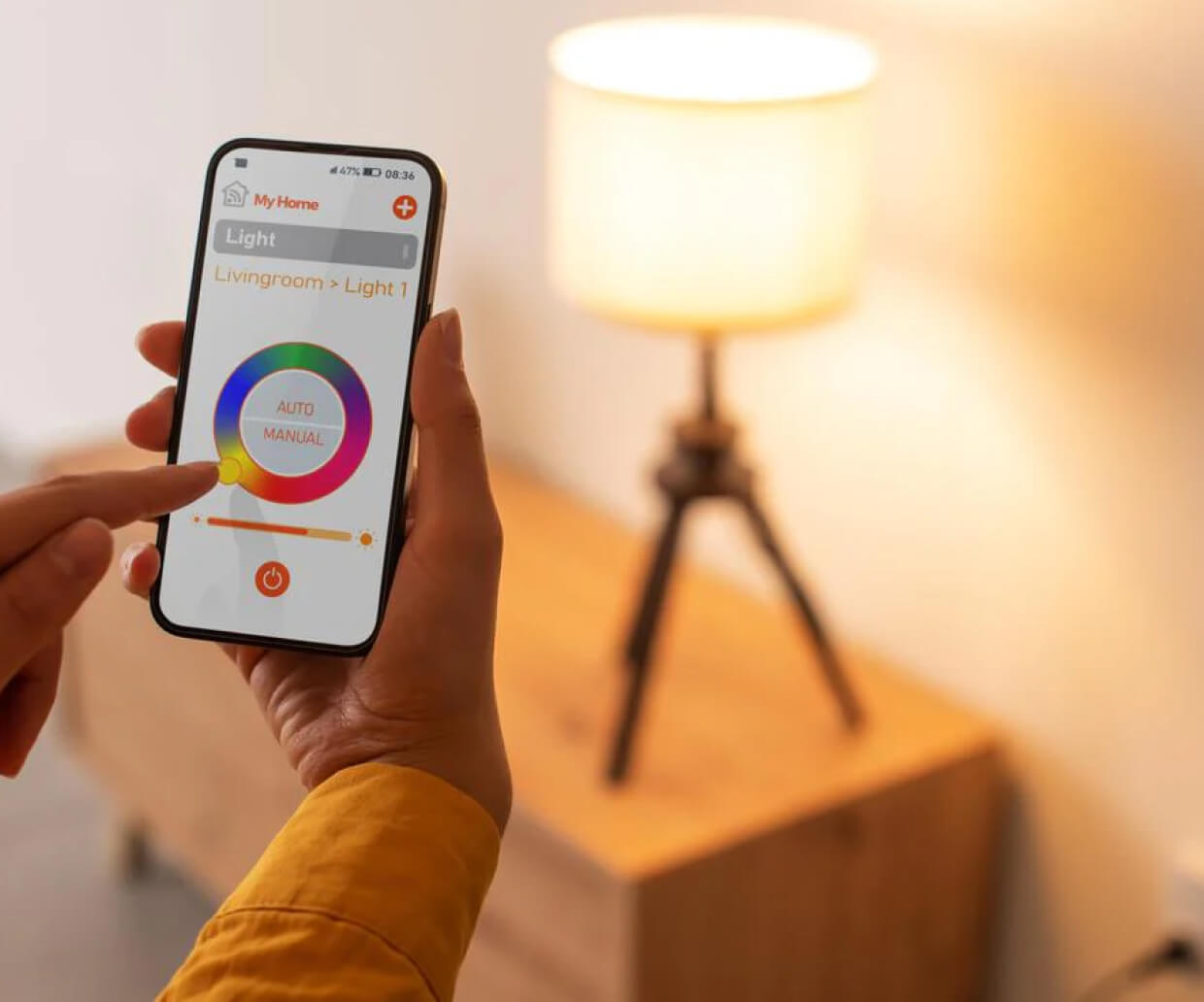 A pair of hands adjusting the color of light in a iPhone