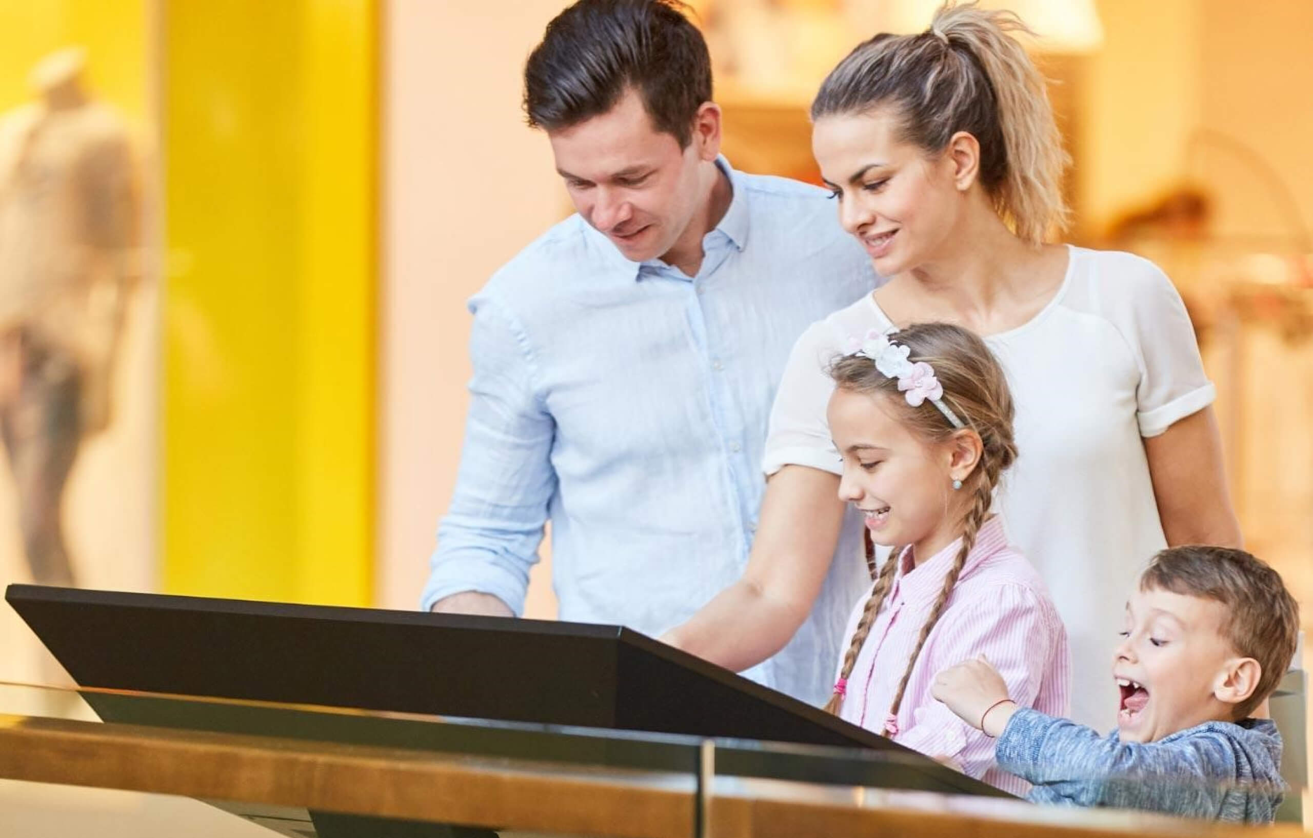 A family using a touch kiosk