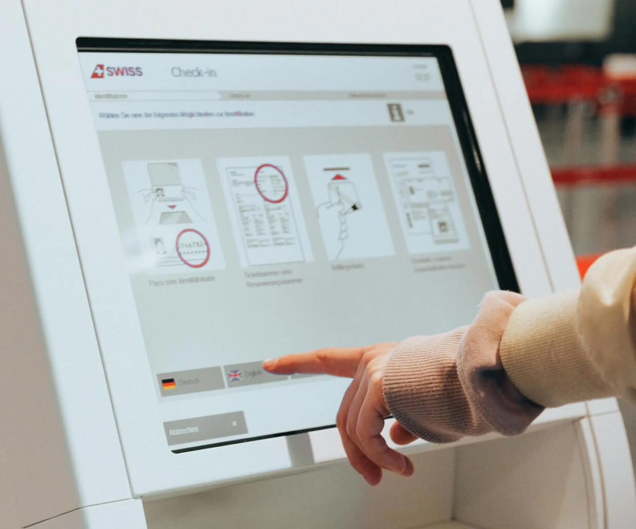 A person interacting with a touch kiosk