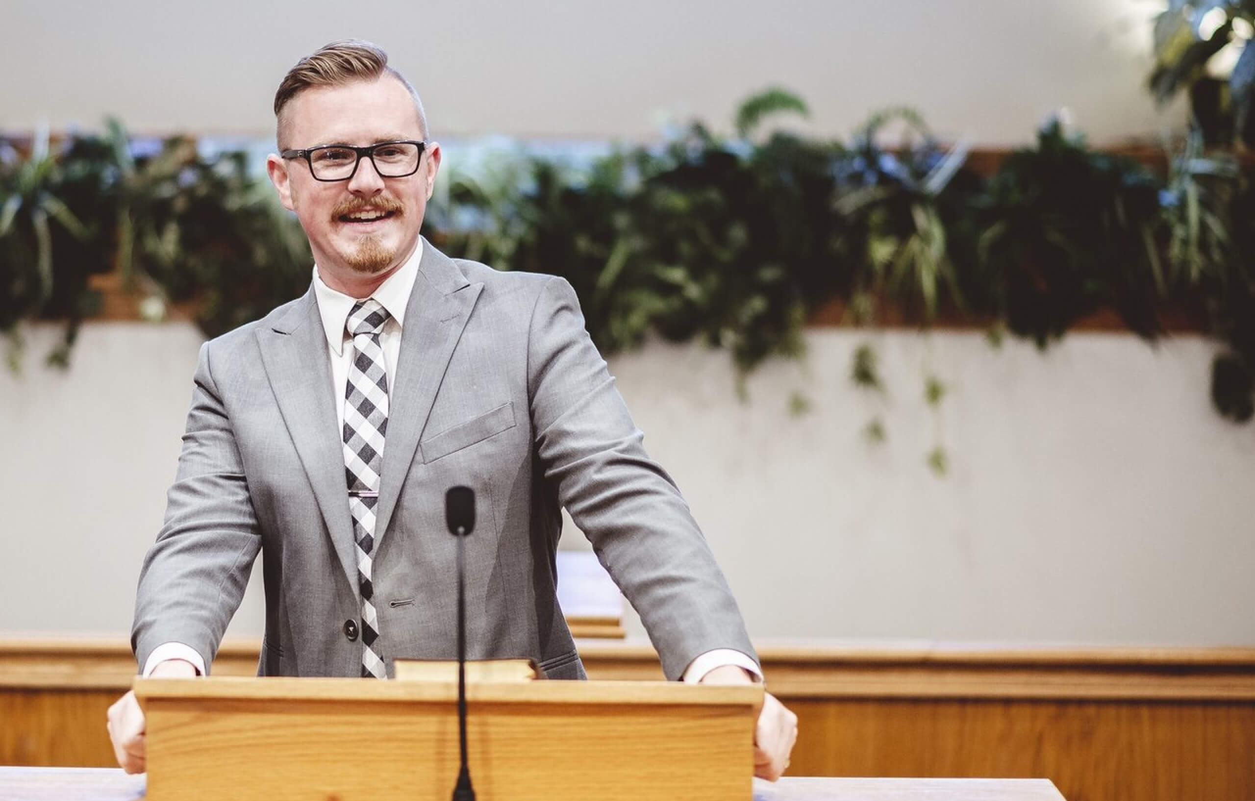 A middle aged white man standing onstage