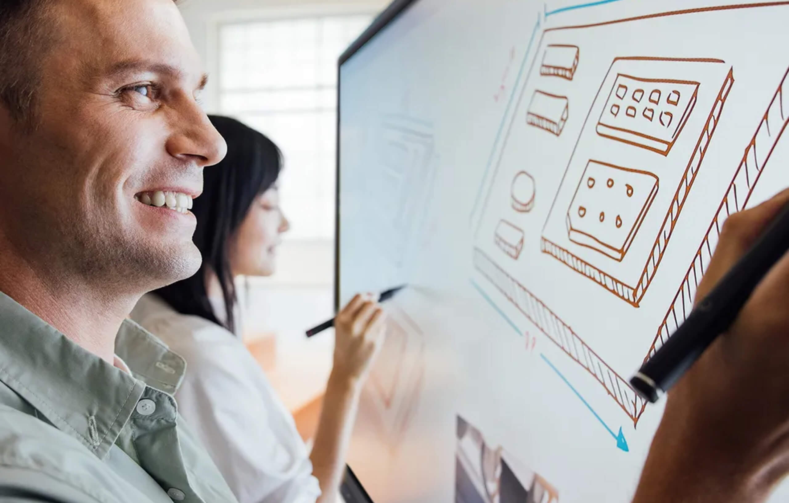 A man drawing on an interactive display