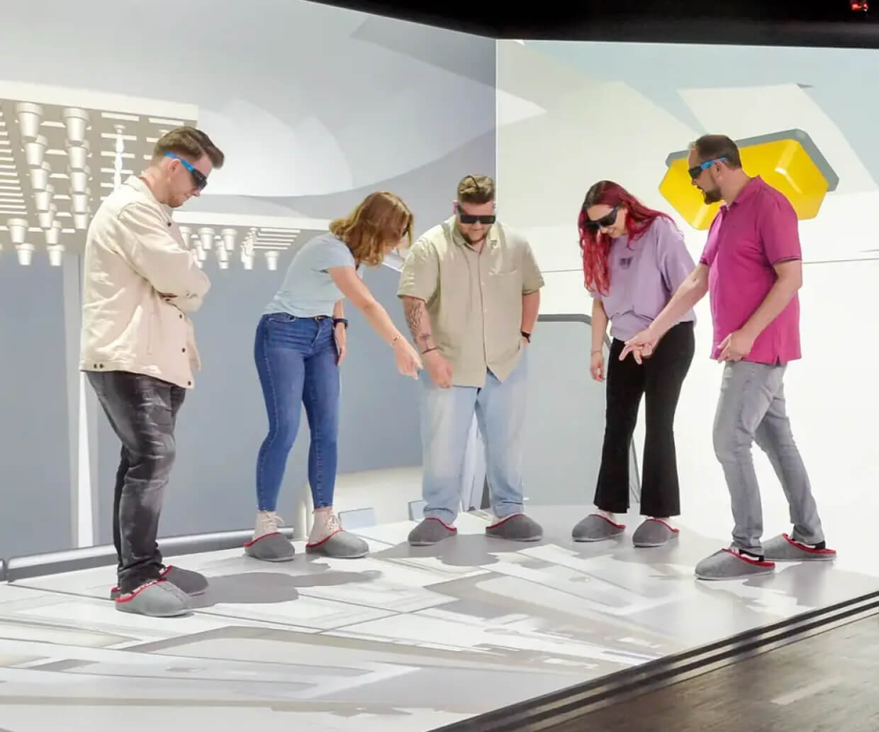 A group of 5 people interacting with an LED floor