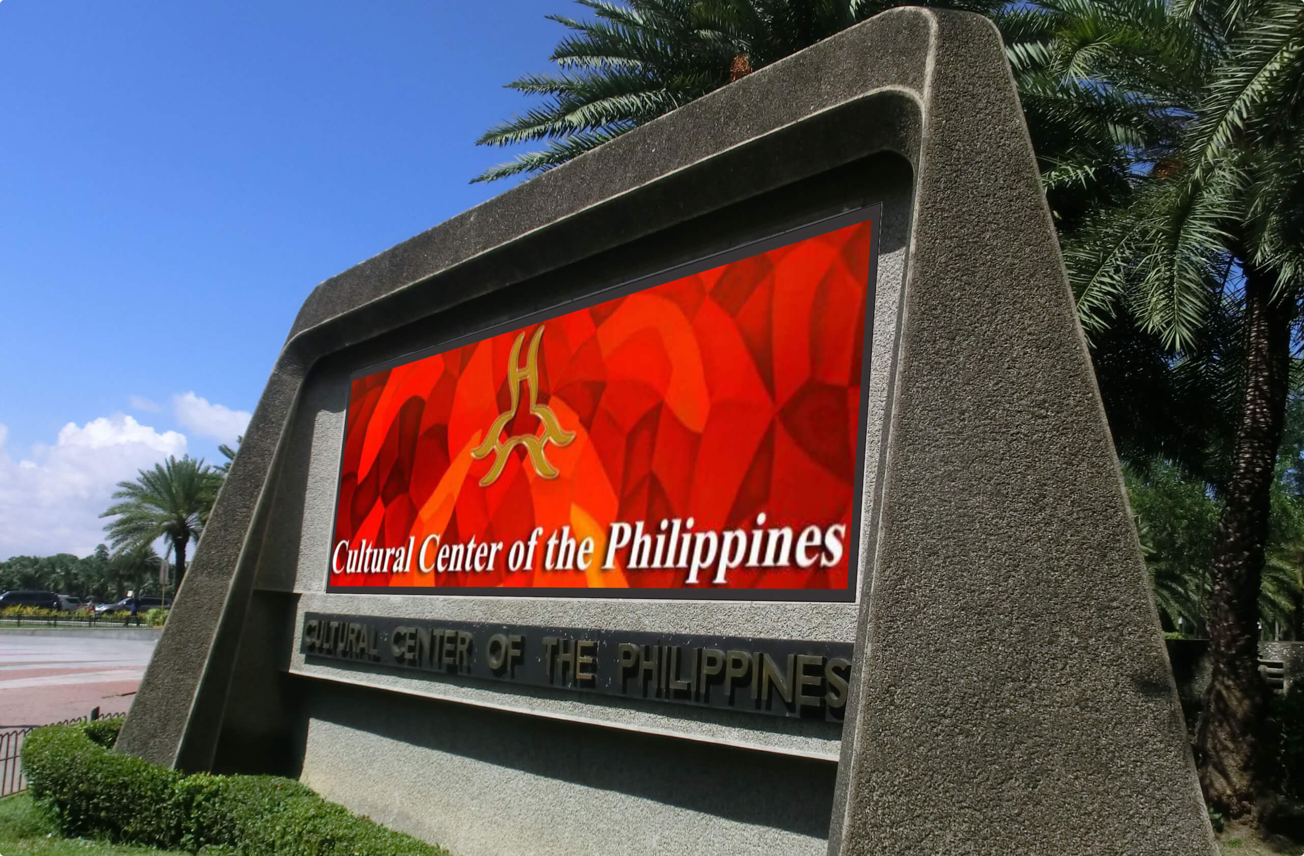 Outdoor signage for the Cultural Center of the Philippines with a red abstract background and gold emblem.