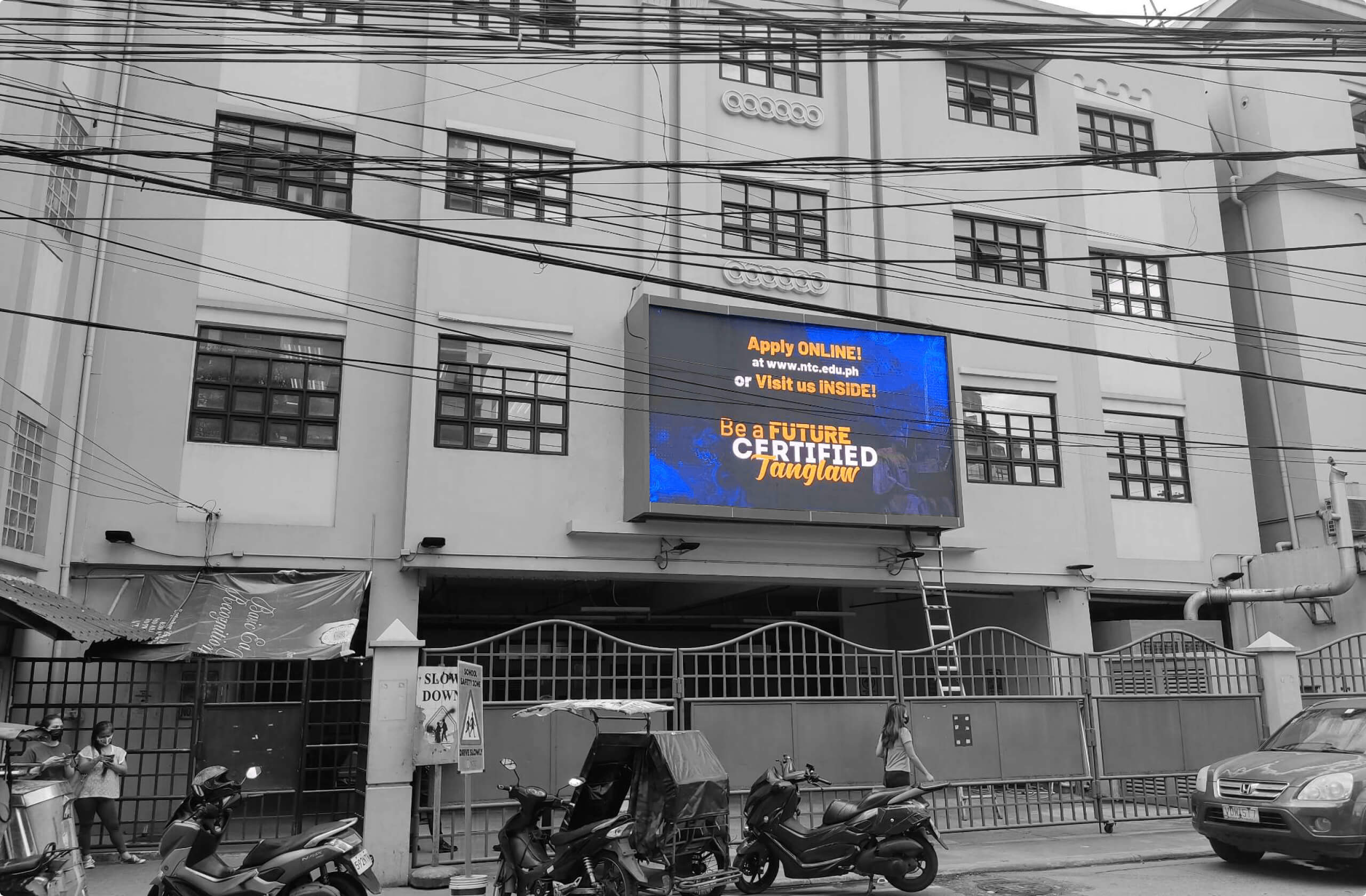Building with digital sign about applying online and becoming a future certified Tanglaw.