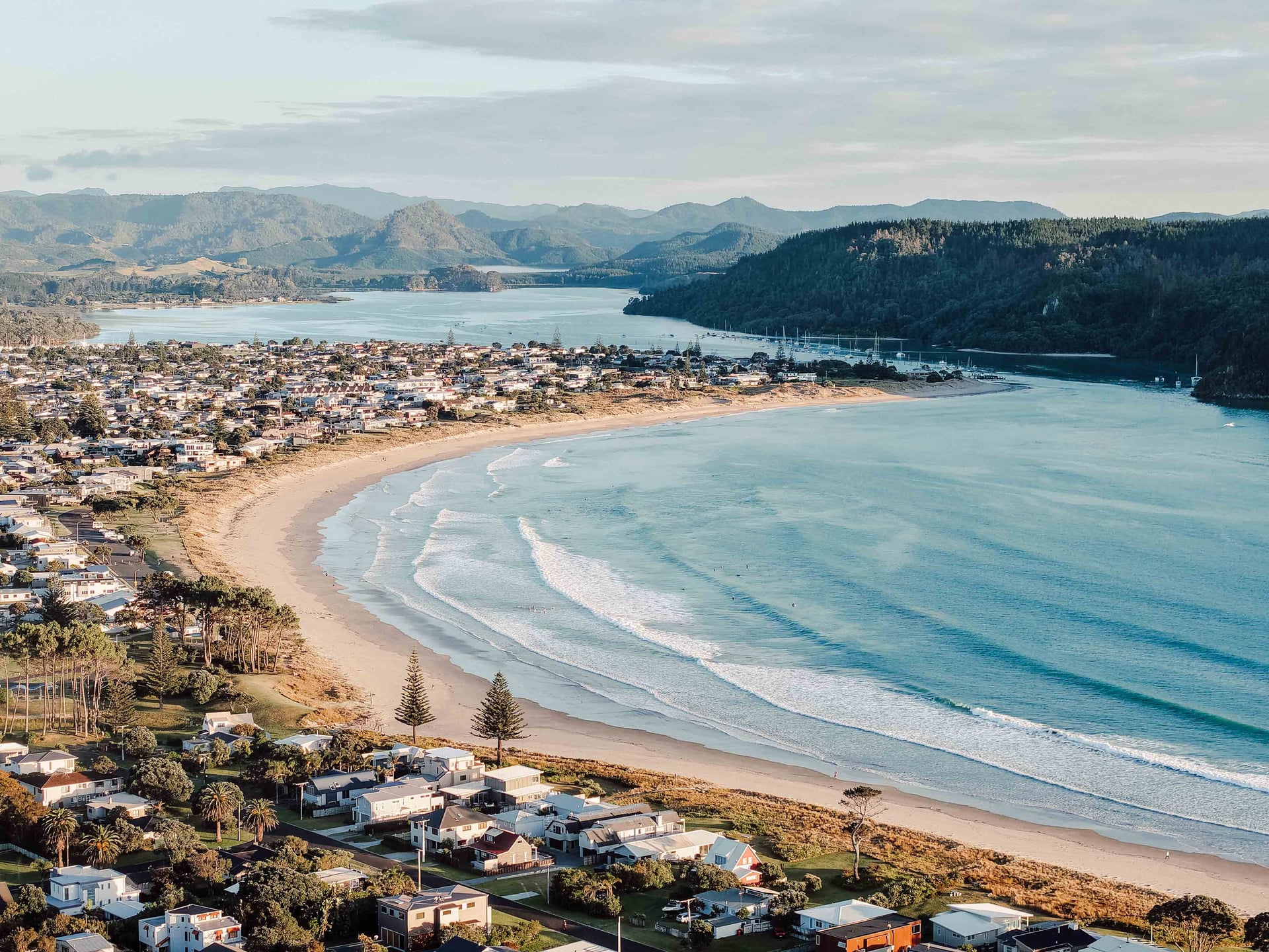 Aerial view of Whangamatā beach, harbour and township, Coromandel