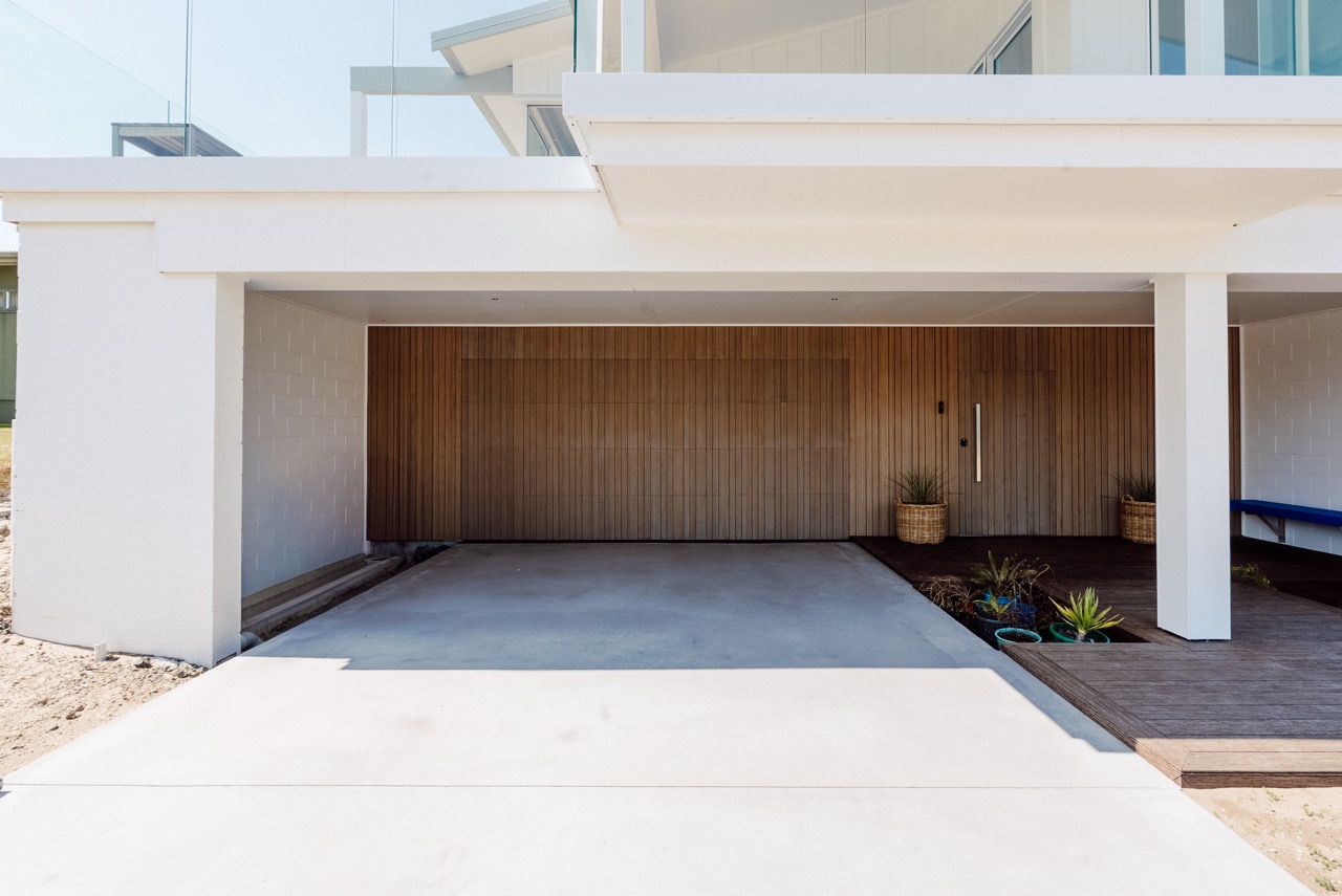 Carport with timber batten garage door at 124 Diana Ave, Whangamatā