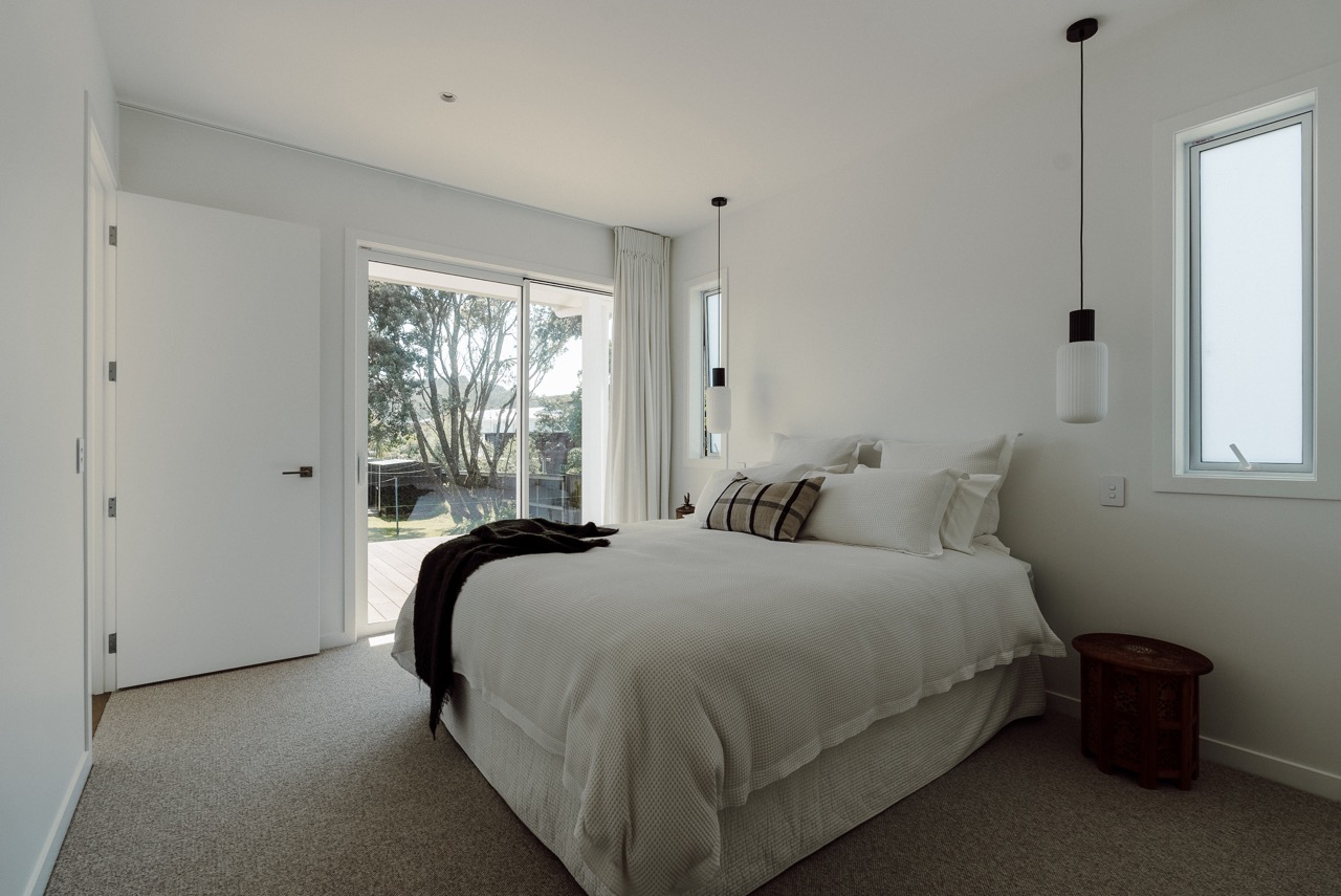 Bedroom with pendant lighting at 124 Diana Ave, Whangamatā