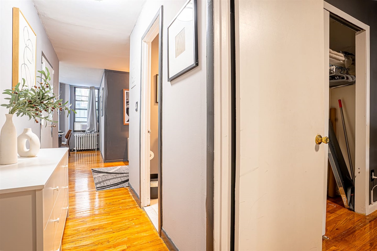 Primary bedroom with plush queen bed, blackout treatments, and smart TV — quiet sleep in midtown Manhattan.