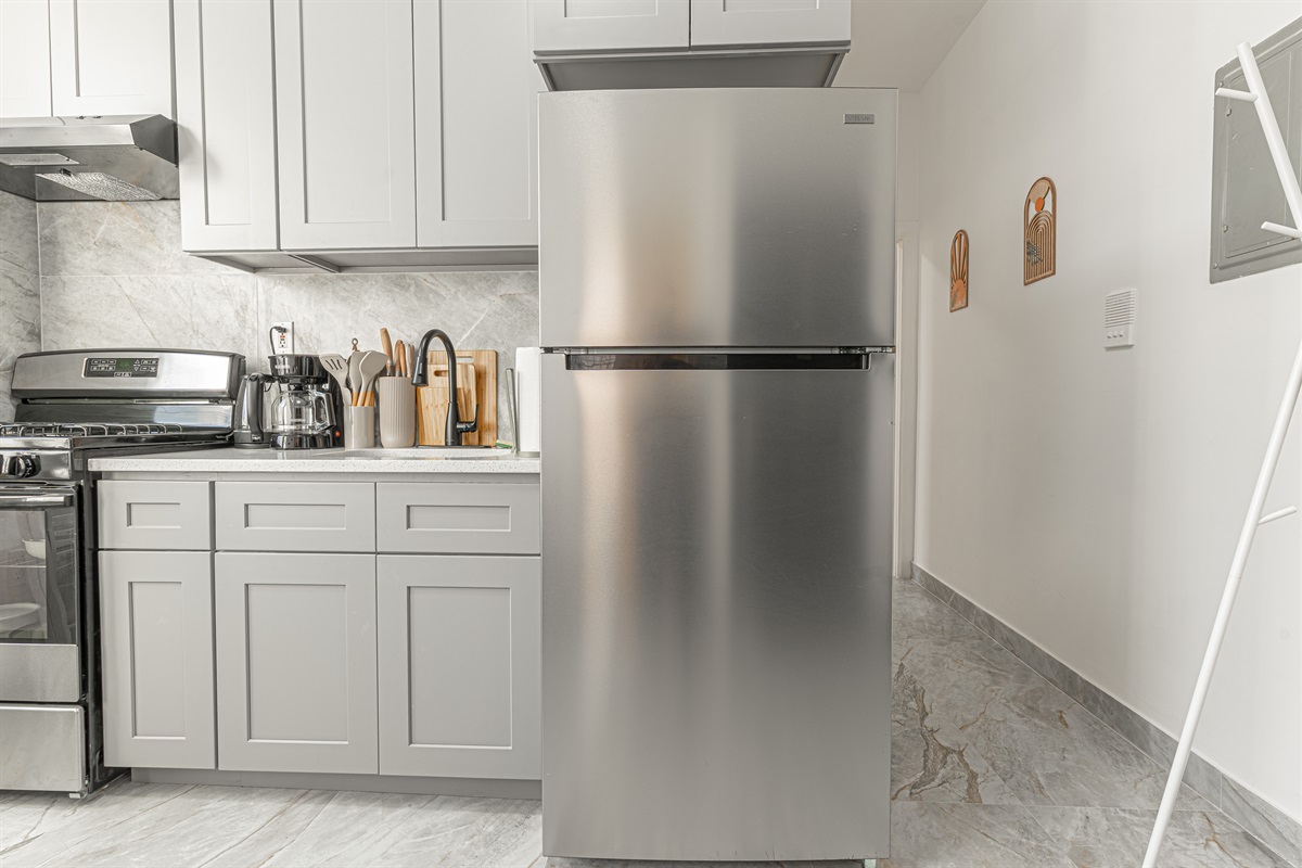 Fully stocked kitchen with full-size fridge and stove — dine in or sample Queens' incredible food scene nearby.
